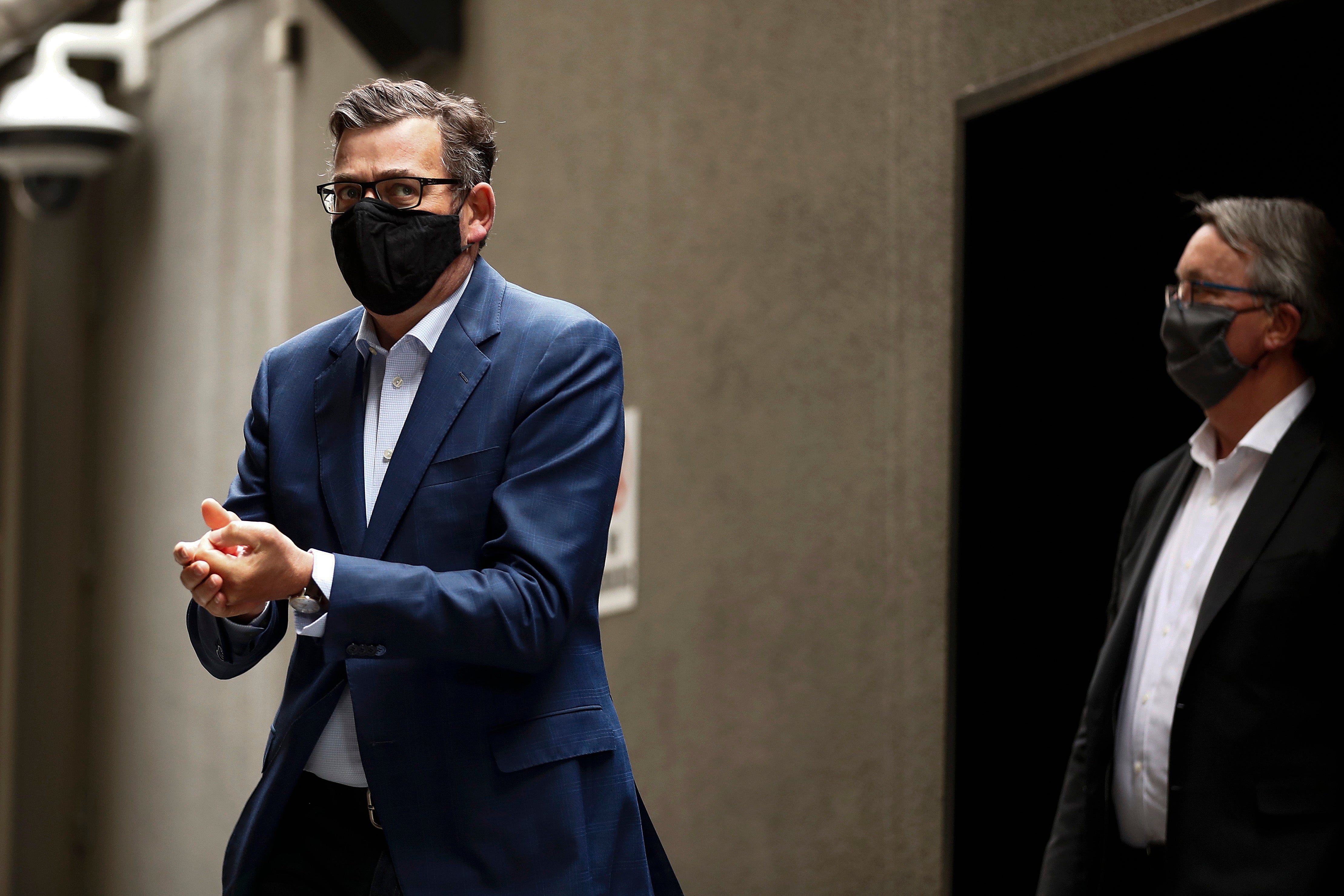 Victorian premier Daniel Andrews (L) and health minister Martin Foley (R) are pictured after a press conference on 20 October, 2020.