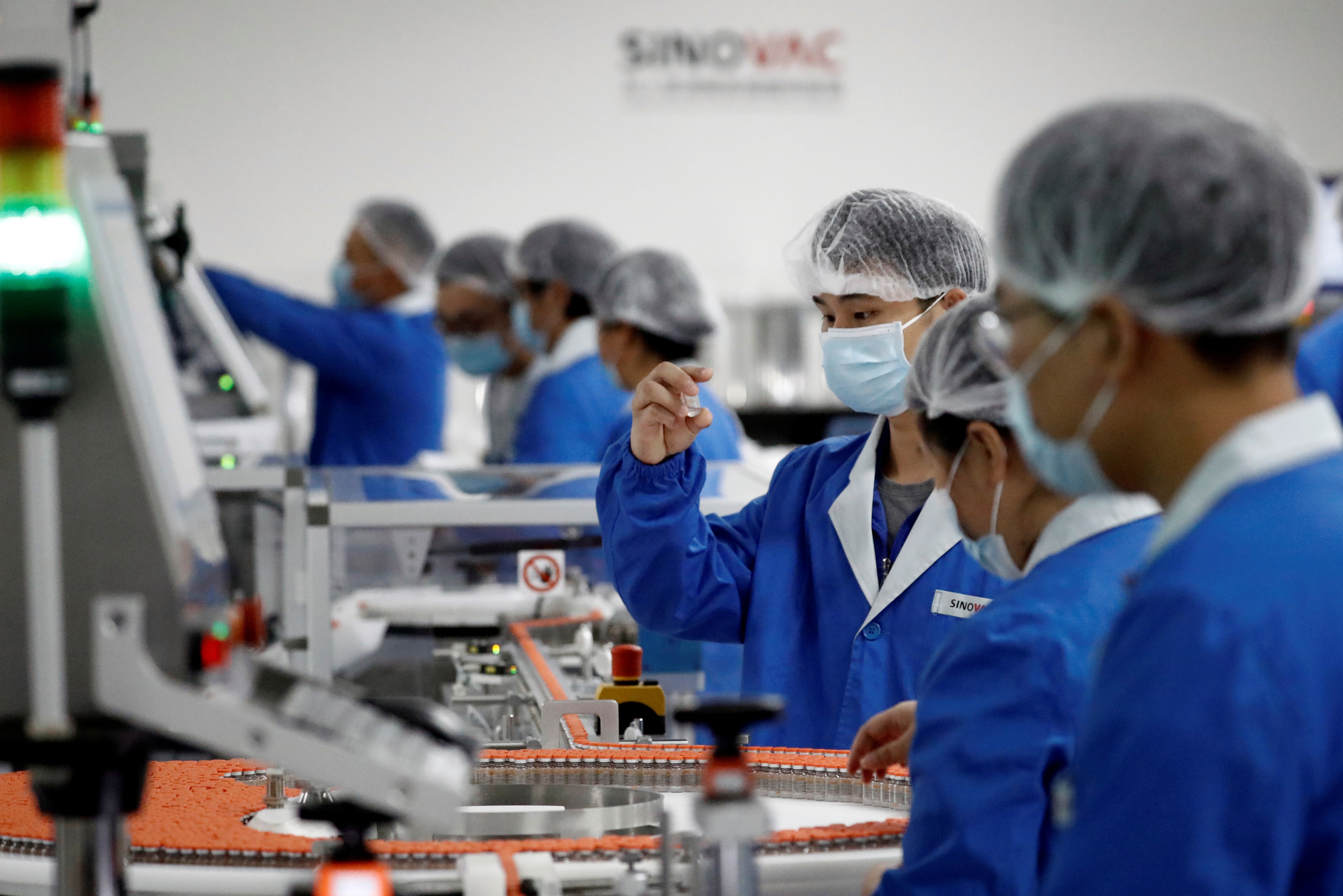 Workers are pictured on 24 September, 2020, at a packaging facility owned by Sinovac, the company that is developing the CoronaVac vaccine.