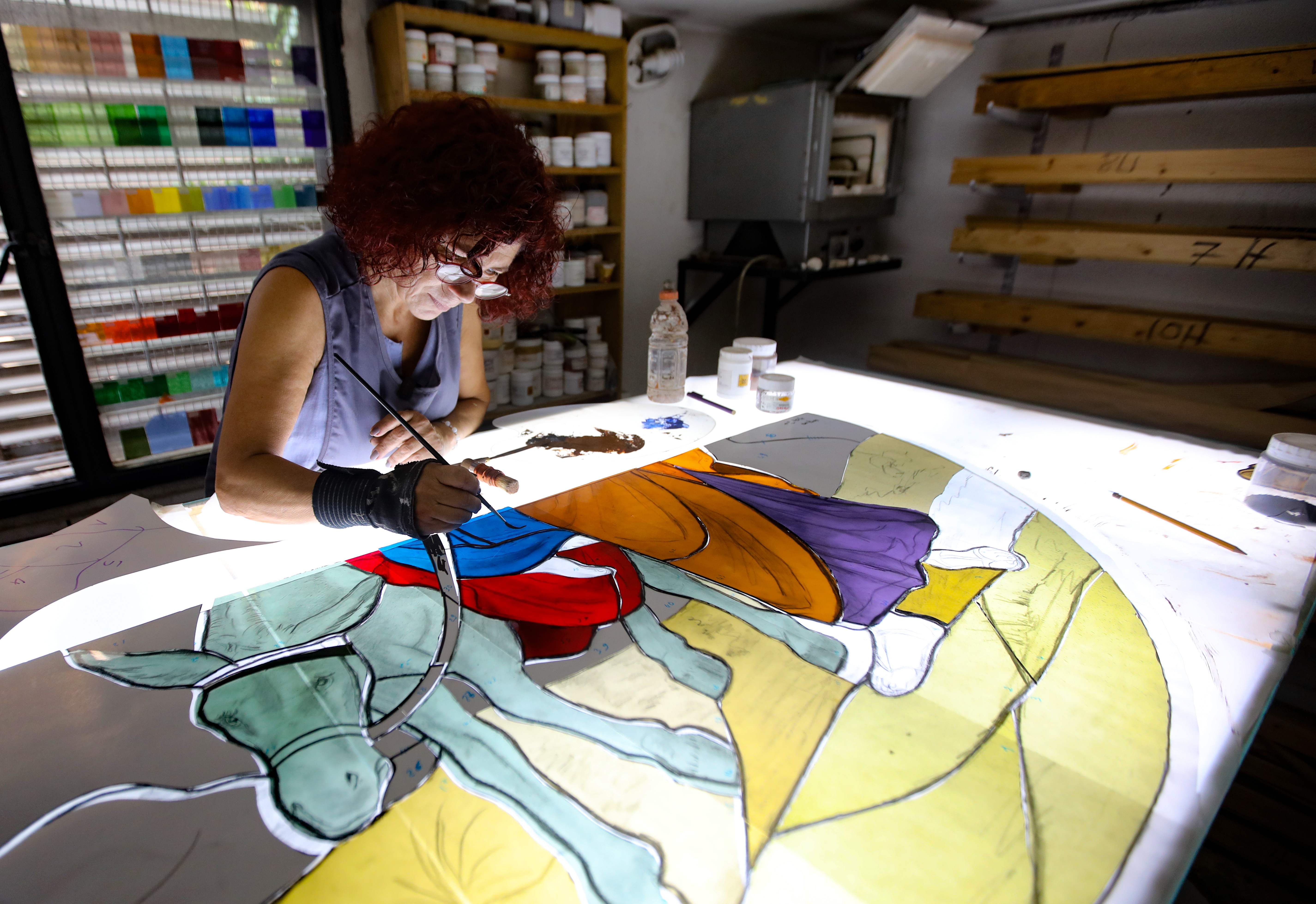 Maya Husseini works on a piece for a cathedral under construction in Jordan, in her basement workshop on the outskirts of Beirut, on 18 September 2020