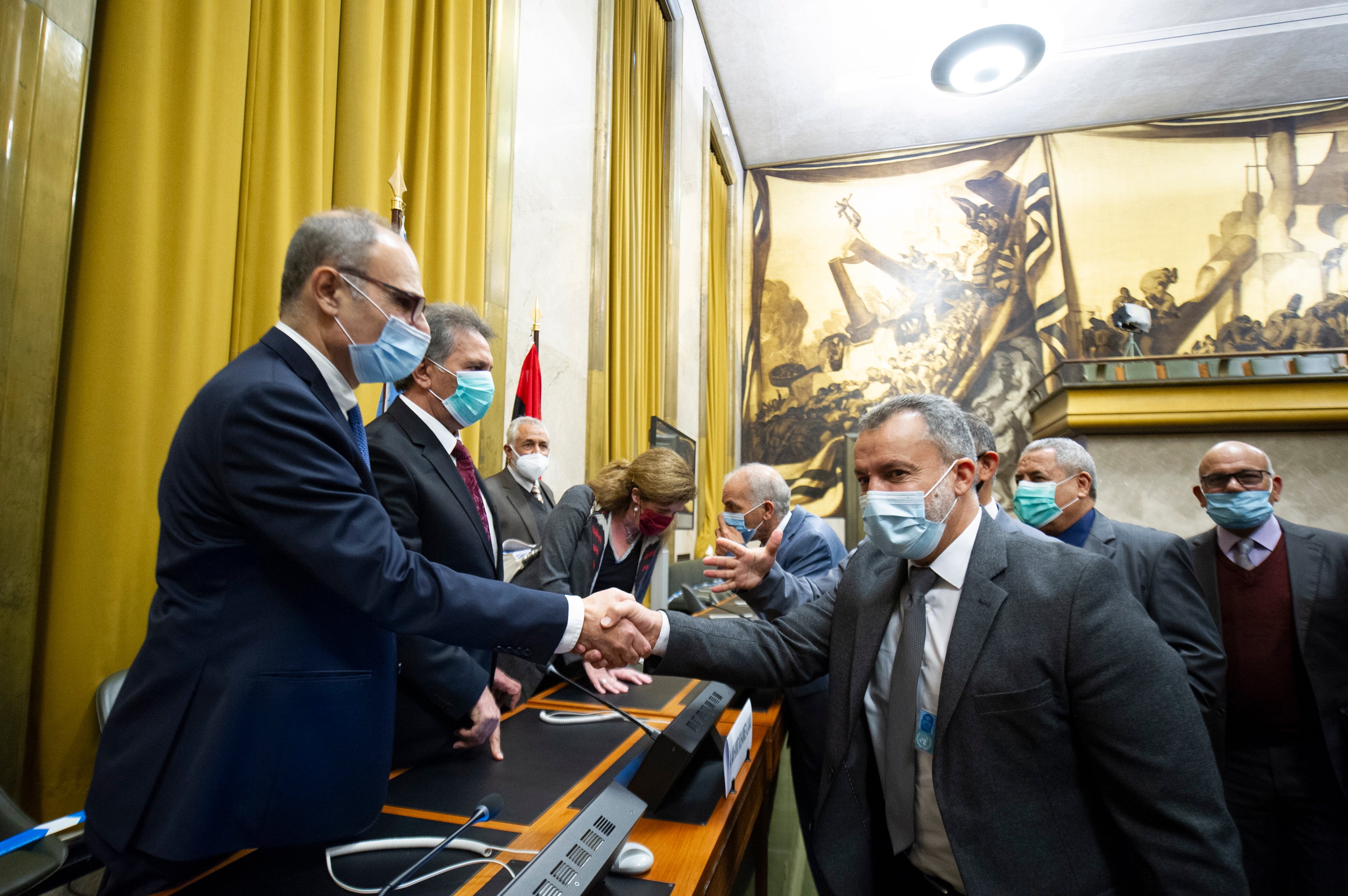 Participants of the fourth round of the 5+5 Libyan Joint Military Commissionsign shaking hands after signing an Agreement for a Complete and Permanent Ceasefire in Libya, at United Nation’s Palais des Nations in Geneva, Switzerland, 23 October 2020. According to the United Nations (UN), the two rival sides in the Libyan civil war have agreed on a nationwide ceasefire. (EPA/Violaine Martin / UN)