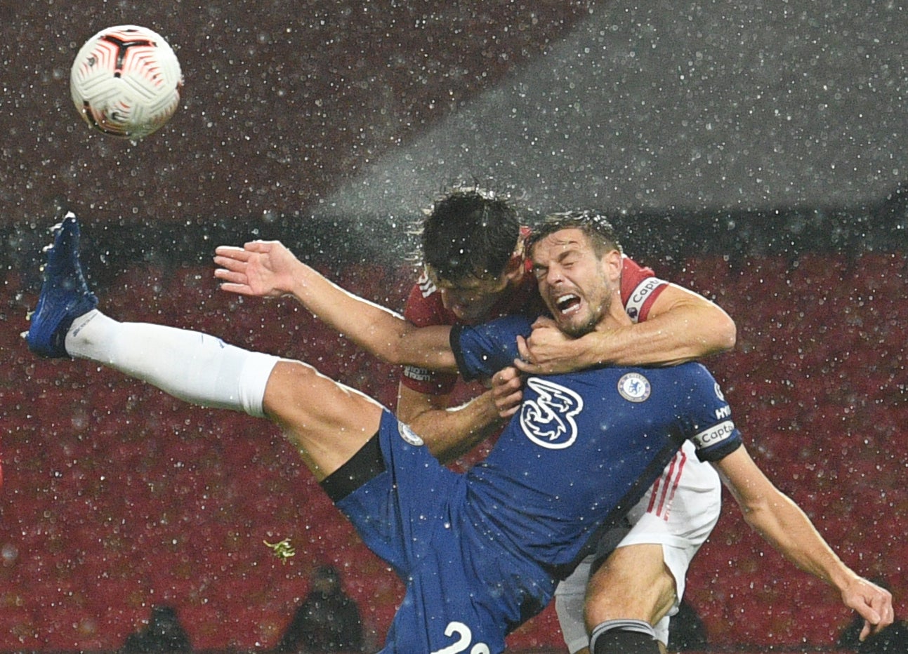 Manchester United defender Harry Maguire challenges Cesar Azpilicueta