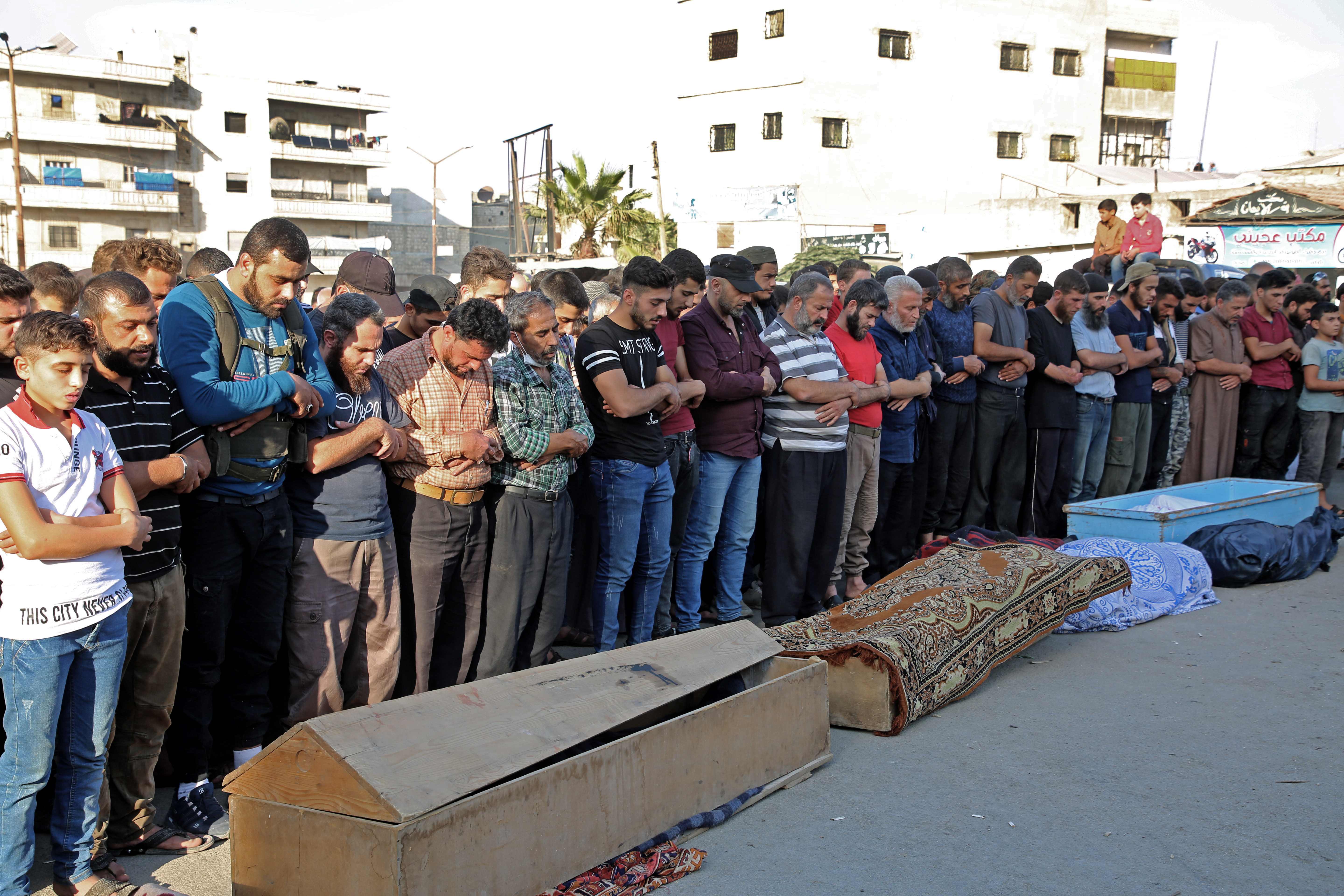 Syrians take part in the funeral of 10 fighters with the Turkey-backed Faylaq al-Sham rebel faction in Syria, in Idlib, on October 26, 2020, following their death in a Russian air strike. (Photo by MOHAMMED AL-RIFAI/AFP via Getty Images)