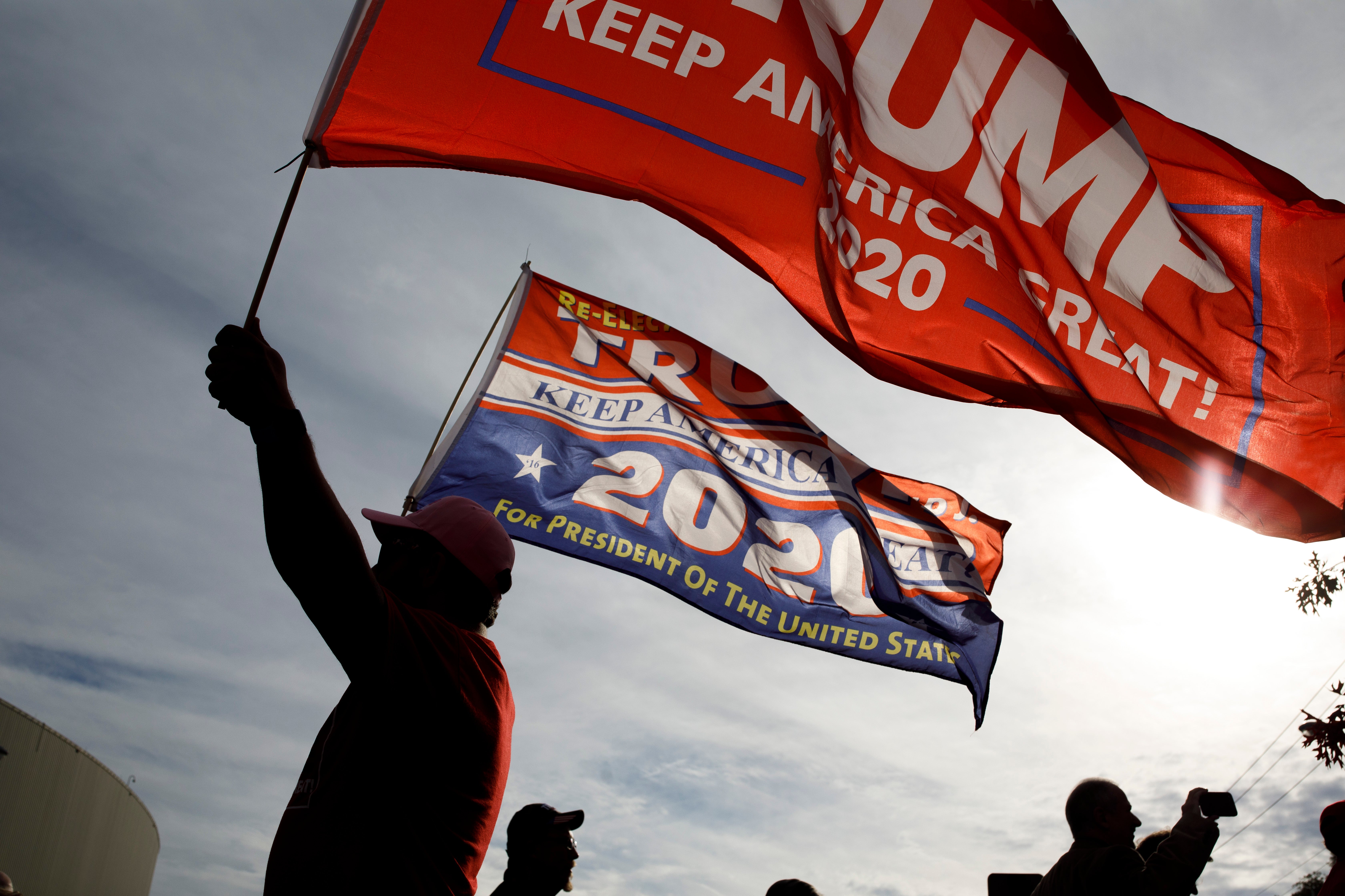 In Washington, a Trump supporter pointed a gun at a group of mostly young protestors after a mysterious liquid was thrown on him.