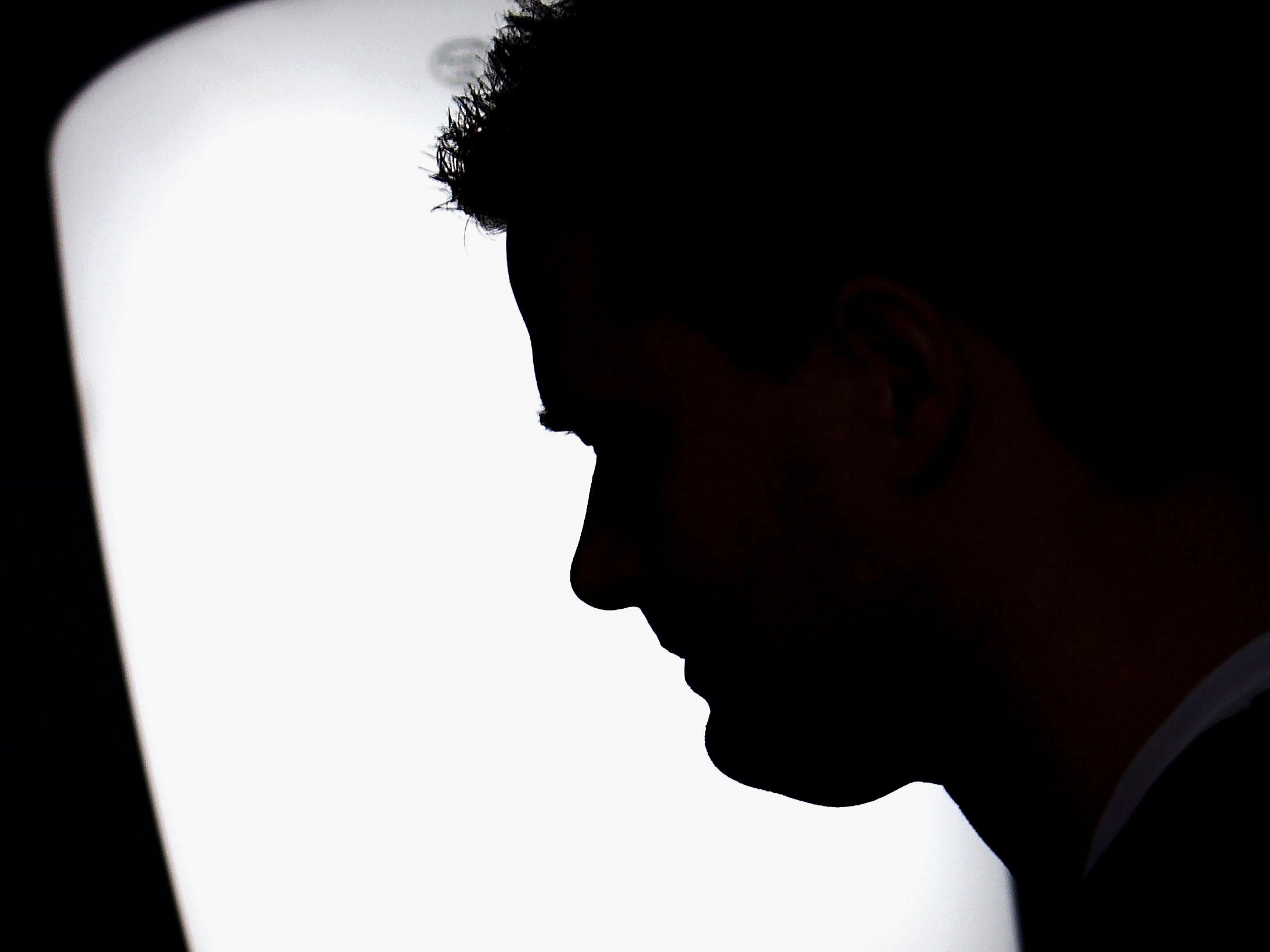 A man suffering from Seasonal Affective Disorder uses a light box in his office to combat the illness