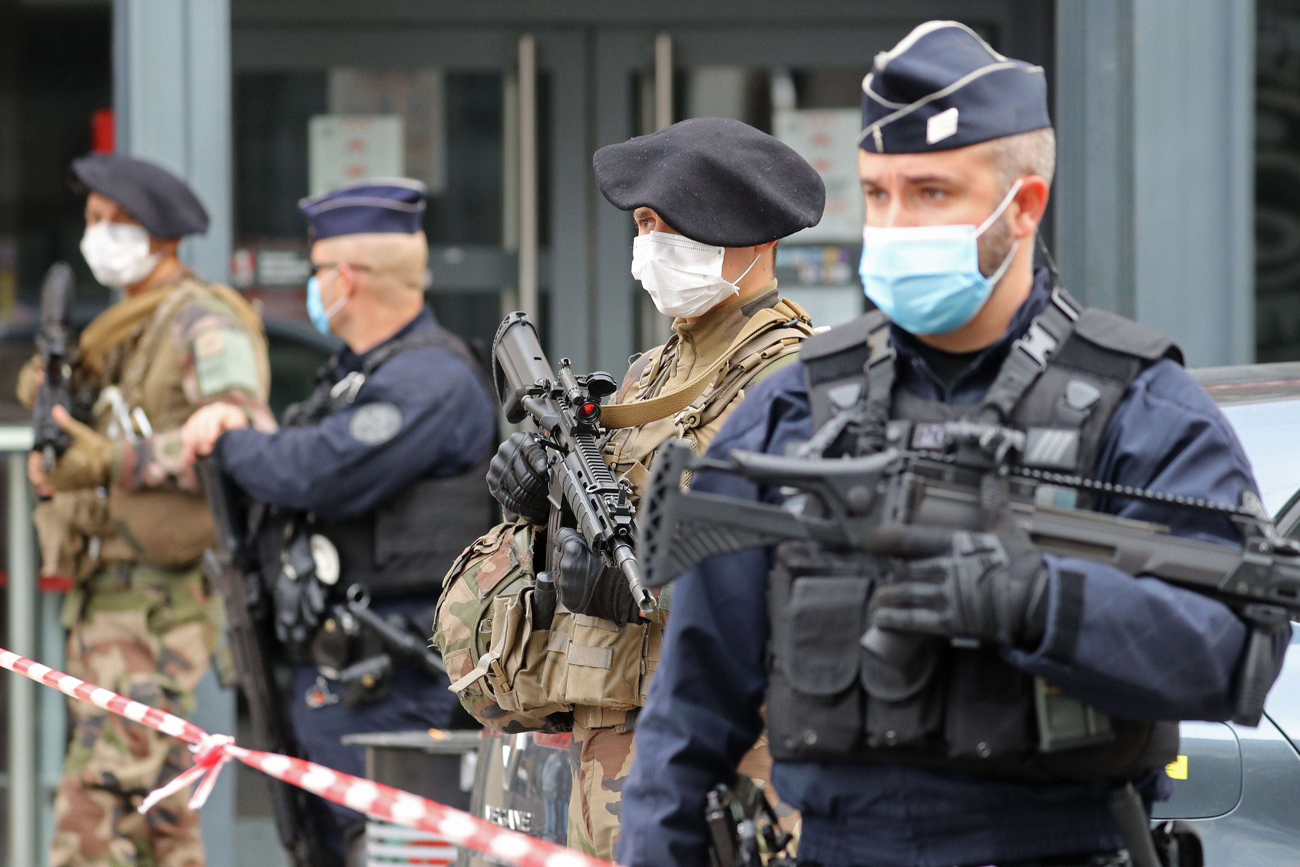 French soldiers and policemen secure the site of the knife attack in Nice