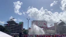 Trump rally organisers fire water from truck as supporters pass out