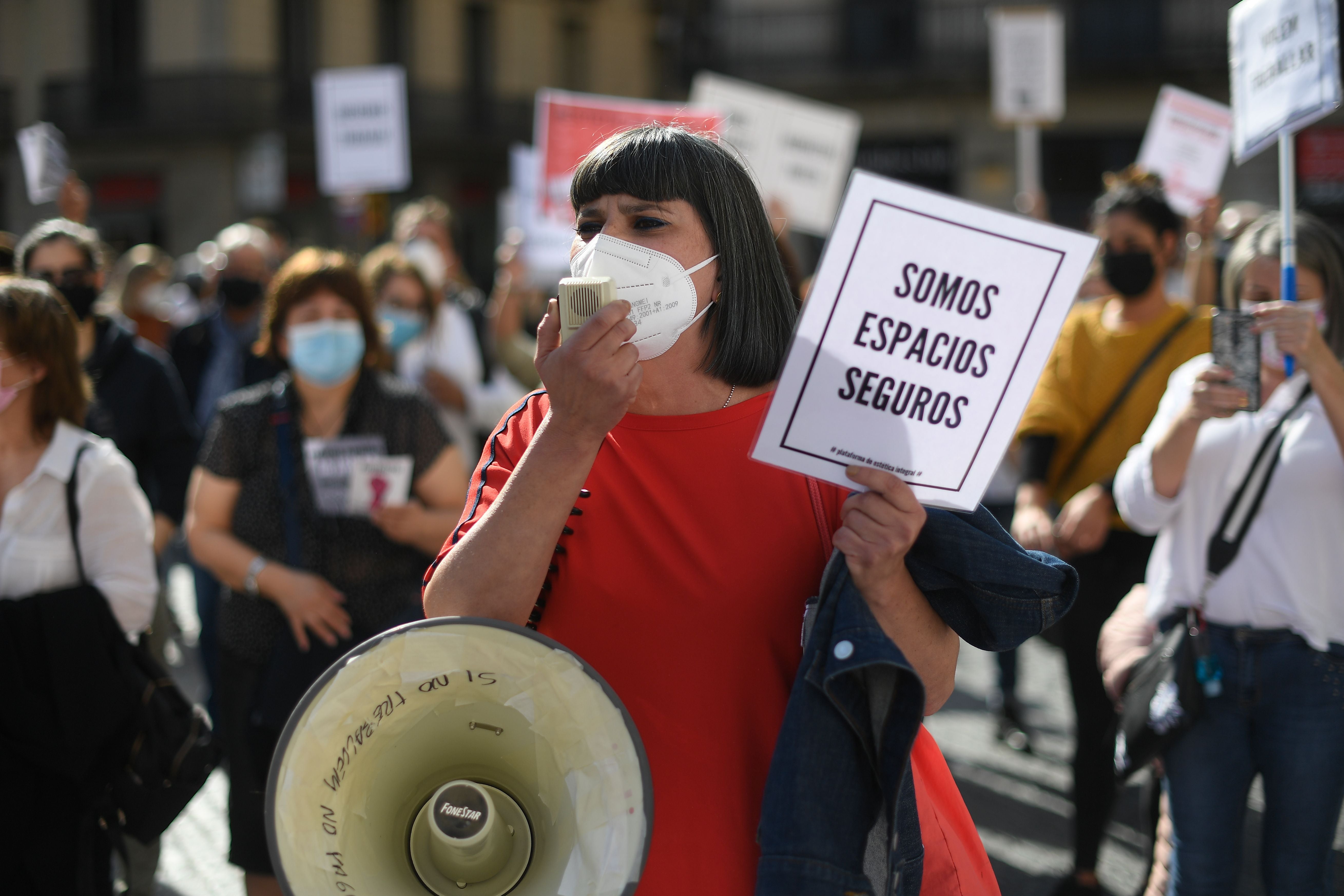 A protester holds a sign reading ‘We are safe spaces’ during a demonstration in Barcelona by restaurant and bar owners to protest against closures&nbsp;