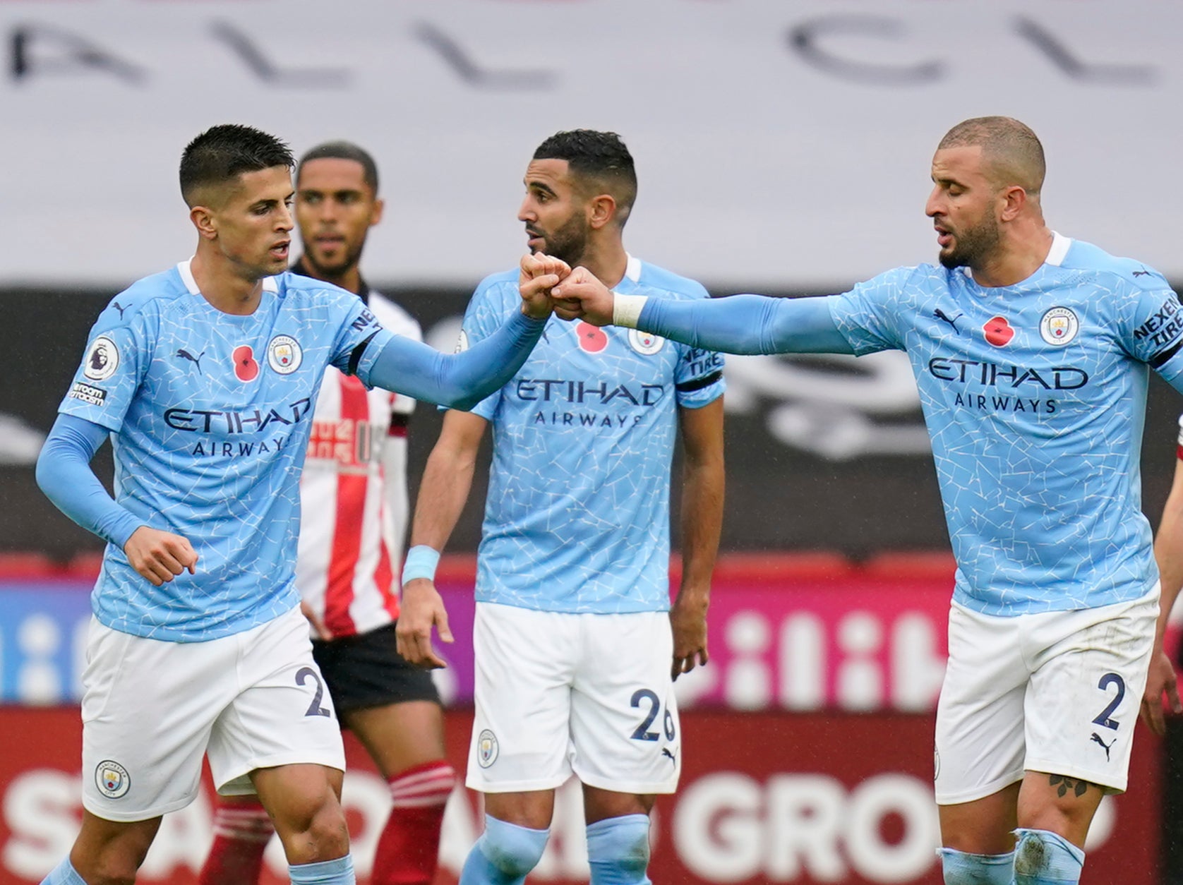 Manchester City’s Joao Cancelo (left) celebrates with fellow defender Kyle Walker (right)