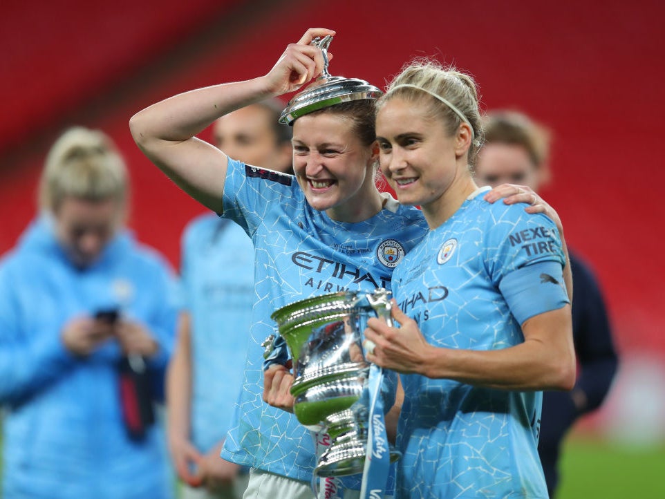 Ellen White and Steph Houghton celebrate with the trophy