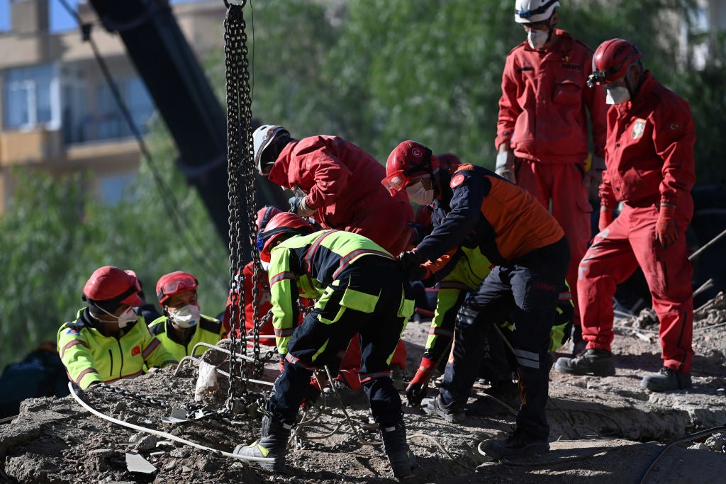 Rescuers are at work during the ongoing search operation at the site of a collapsed building as they look for survivors and victims in the city of Izmir