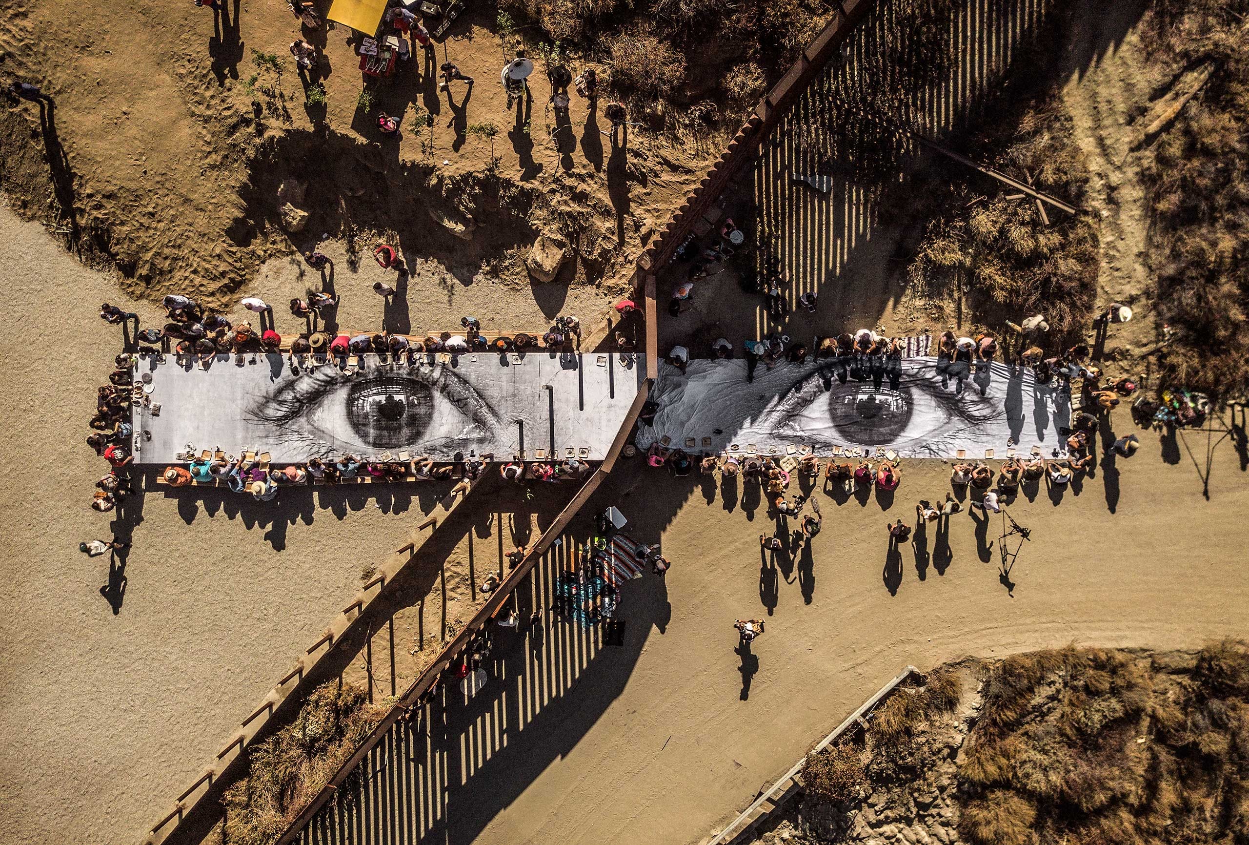 ‘Migrants, Mayra, Picnic across the Border, Tecate, Mexico-USA, 2017’. Installation image. Wheat-pasted poster on table