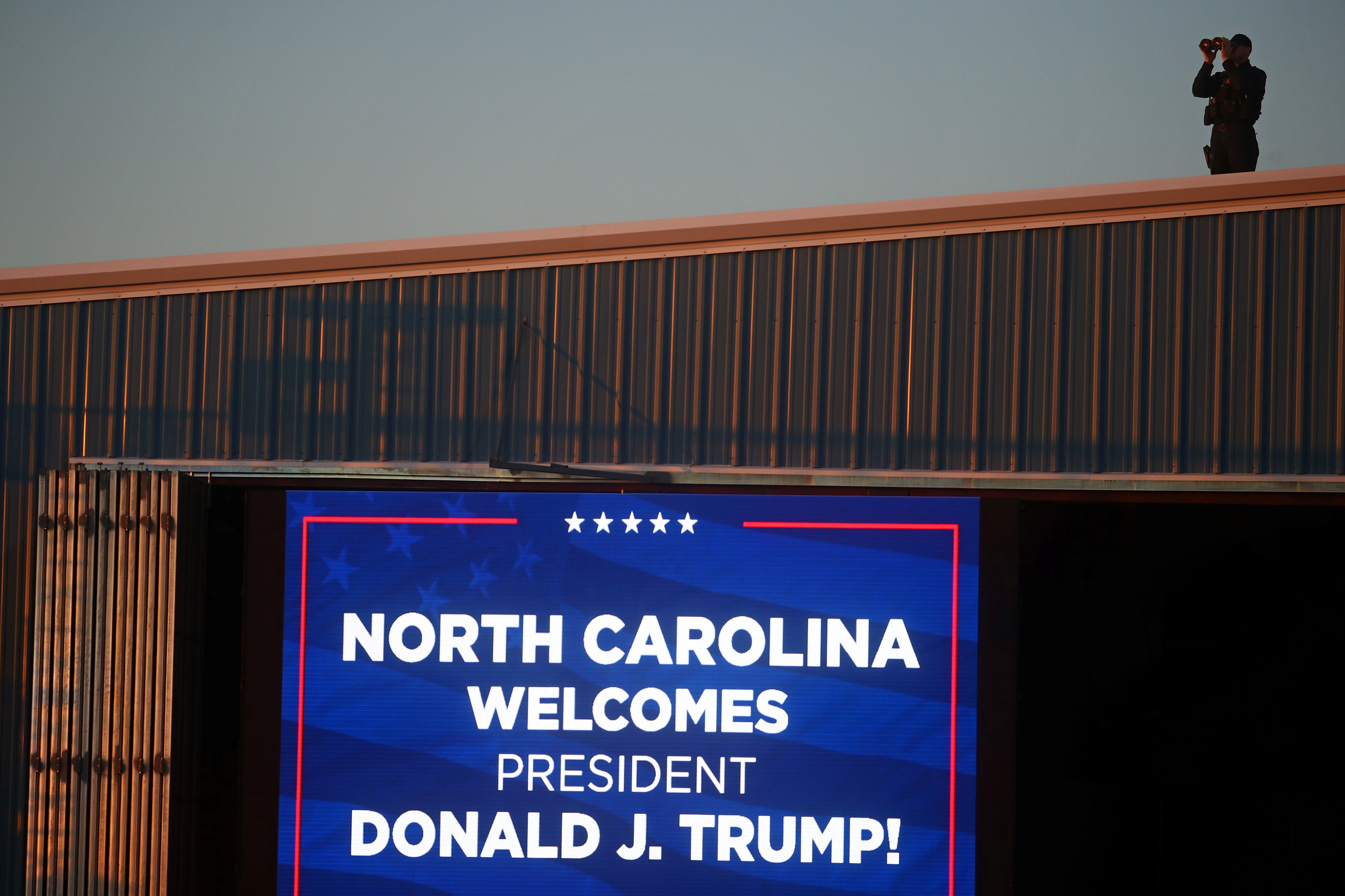 A Secret Service agent watches over preparations for a Trump rally in Hickory, NC