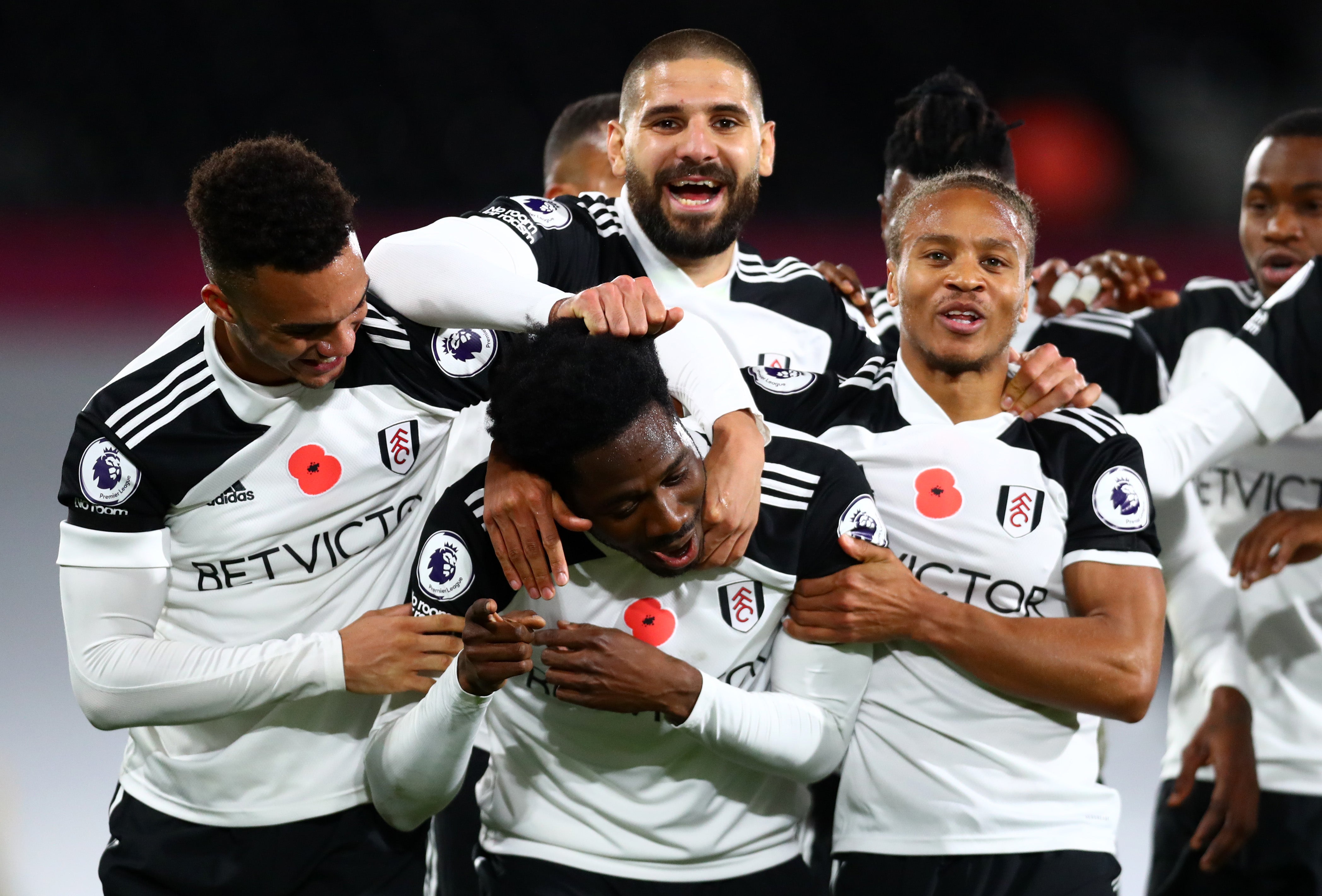 Ola Aina is mobbed by his teammates after a stunning strike