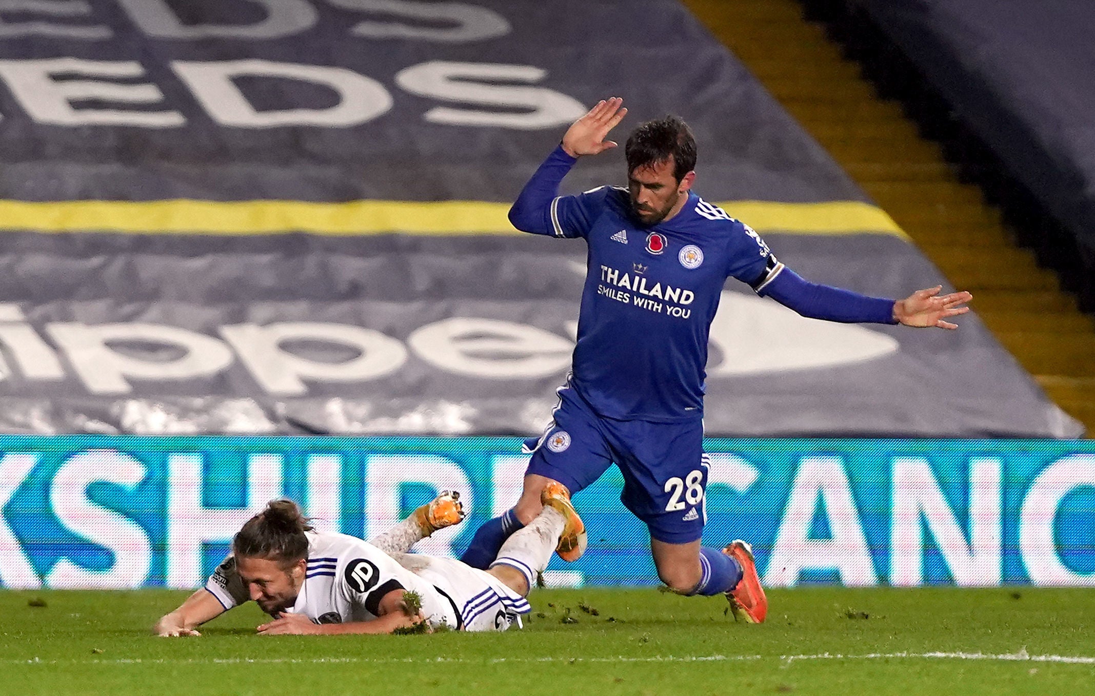 Luke Ayling goes down under a challenge by Christian Fuchs