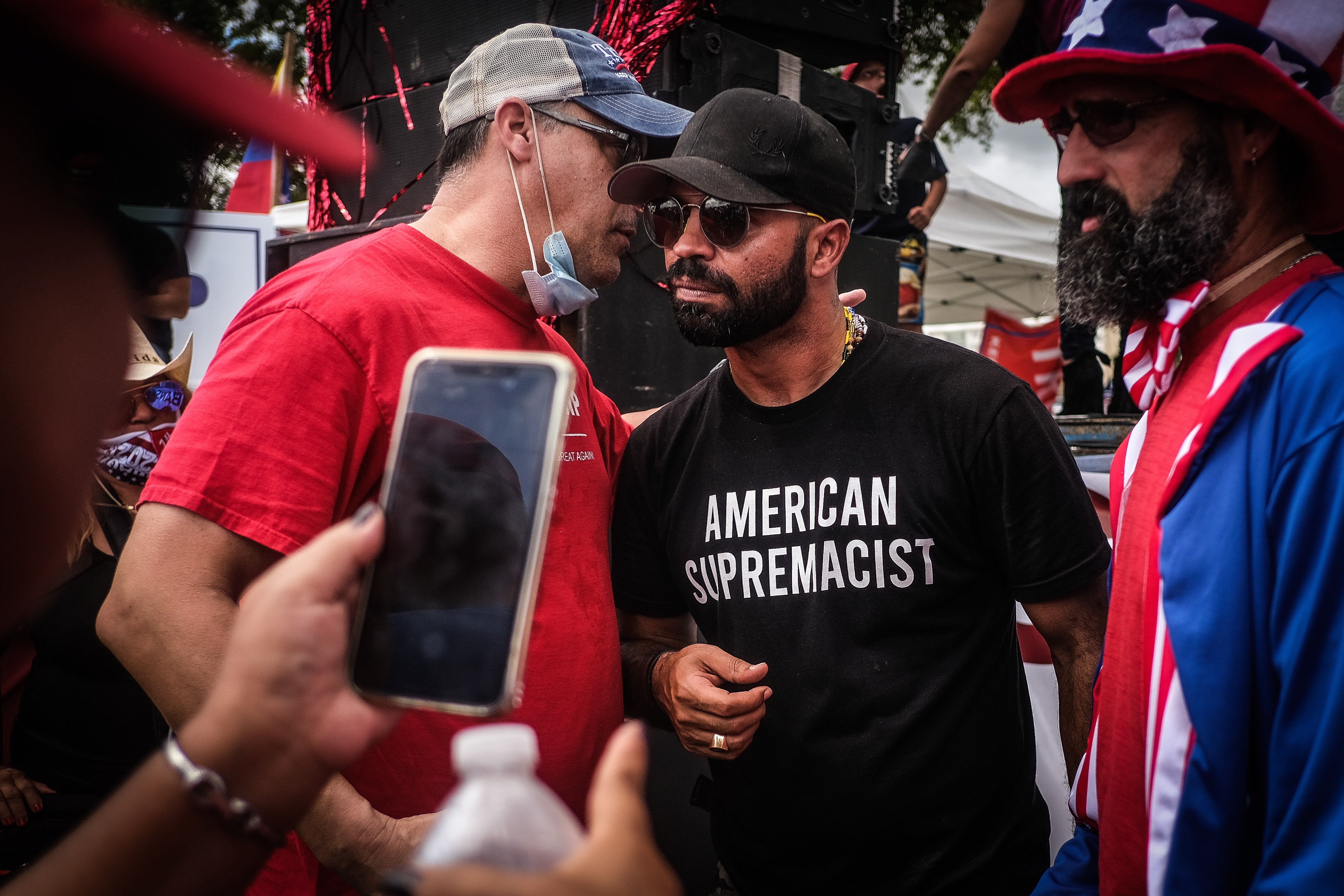 Enrique Tarrio (C), chairman of the Proud Boys, interacts with supporters during the 'Latinos for Trump' demonstration in Miami on 18 October