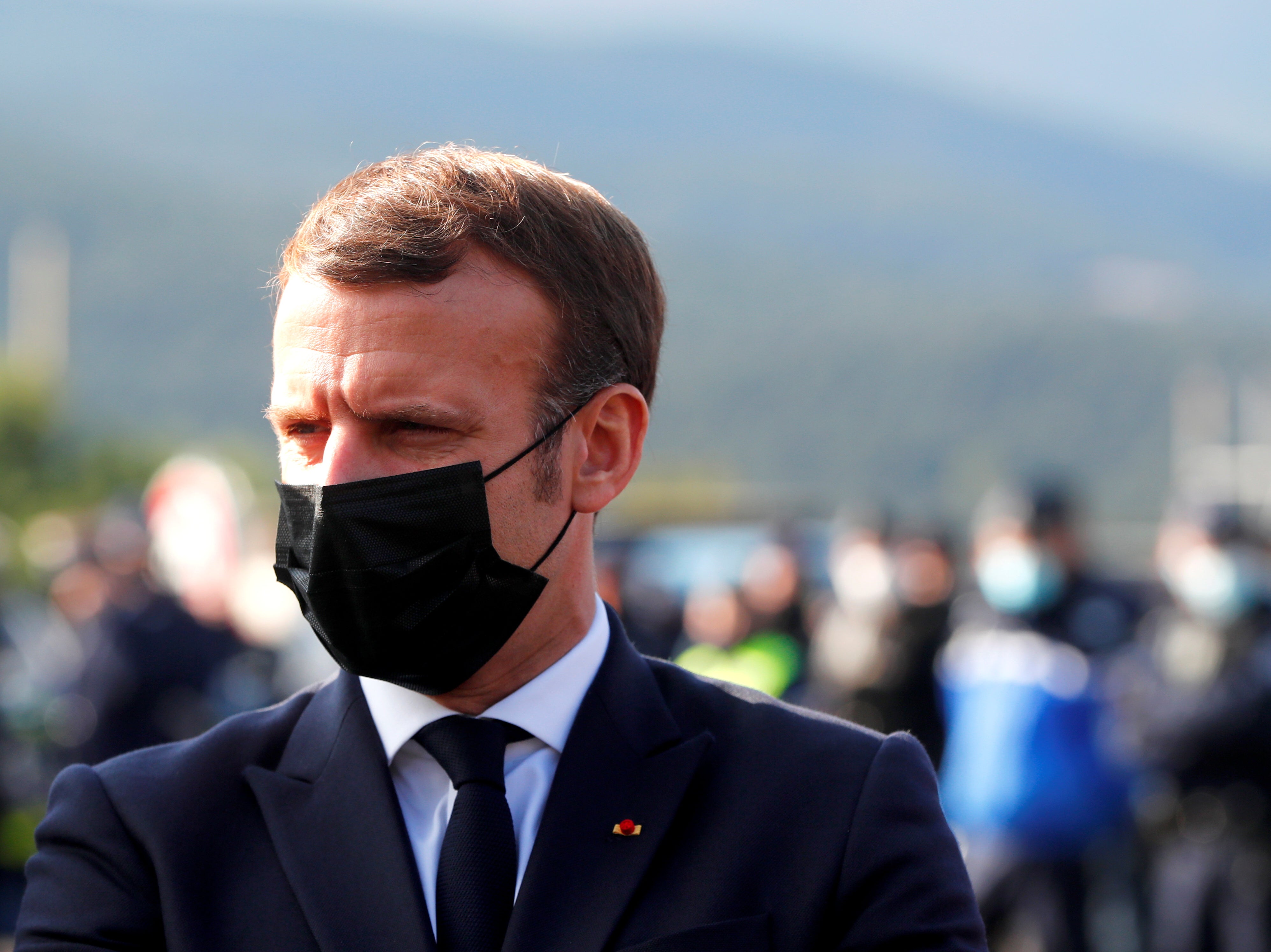 The French president speaks to police officers during a visit to the Le Perthus border crossing