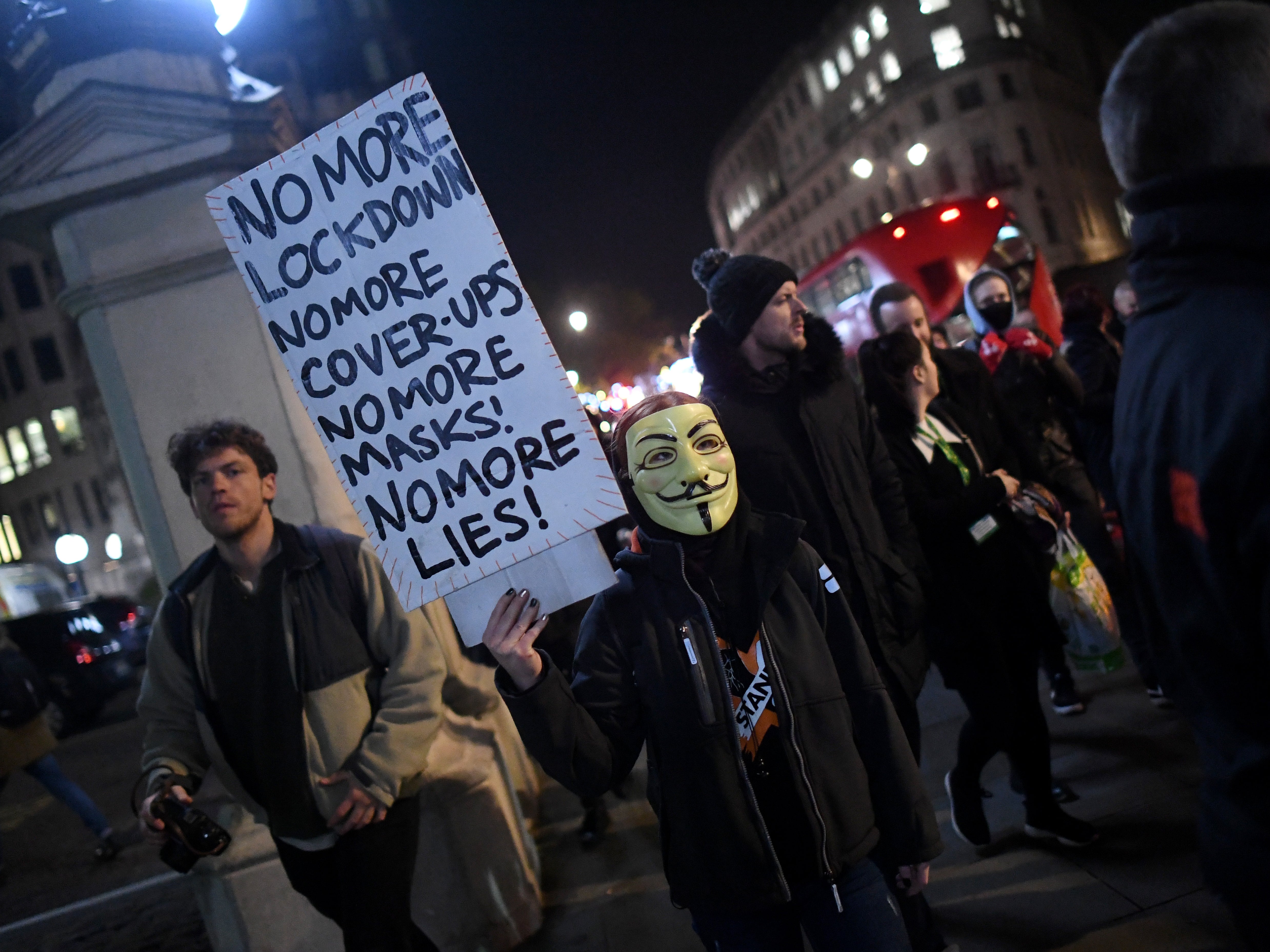 An anti-lockdown protester wears a Guy Fawkes mask in Trafalgar Square