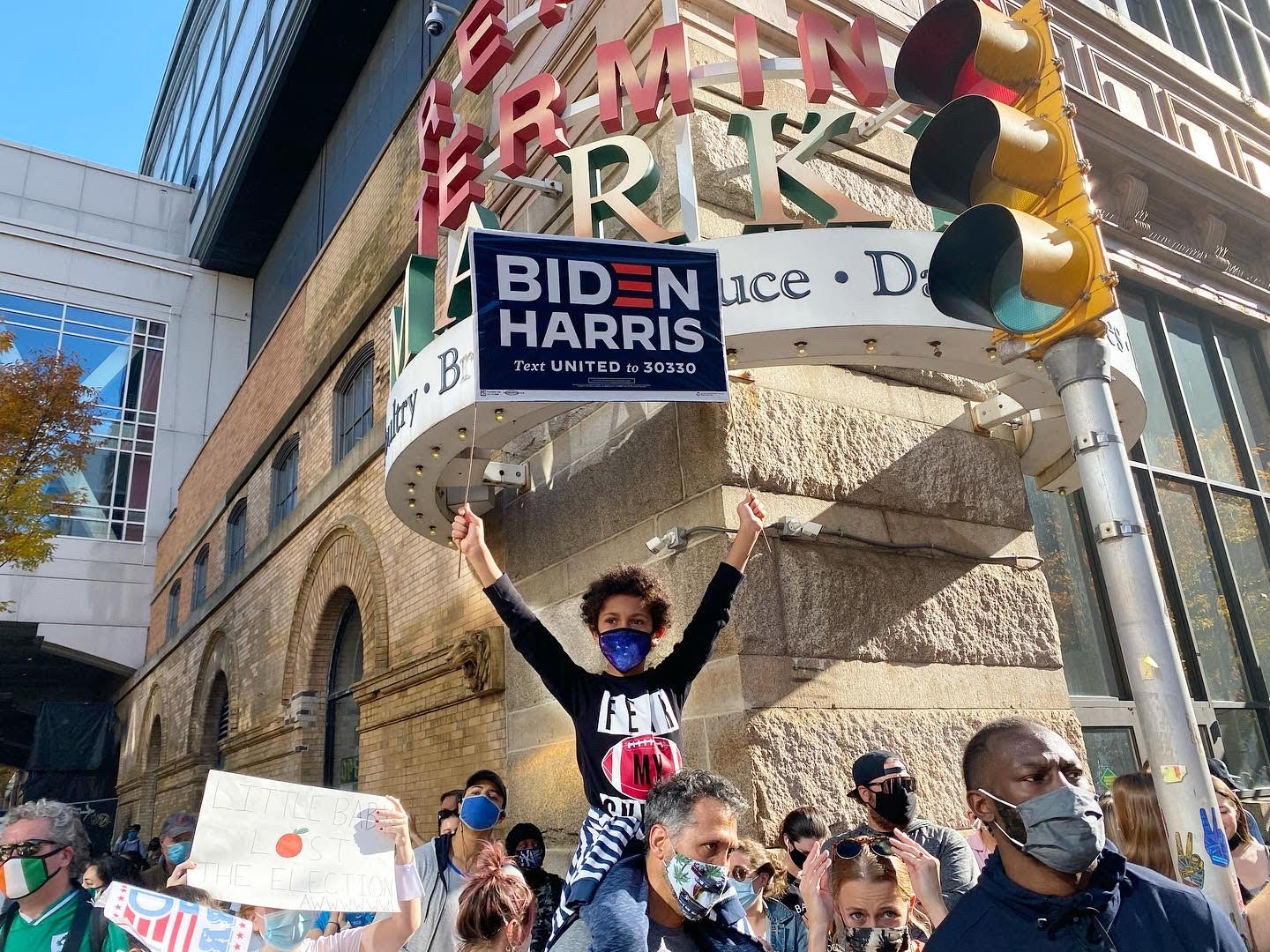 A girl holds up a Biden/Harris sign at a celebration outside the Pennsylvania Convention Centre in Philadelphia