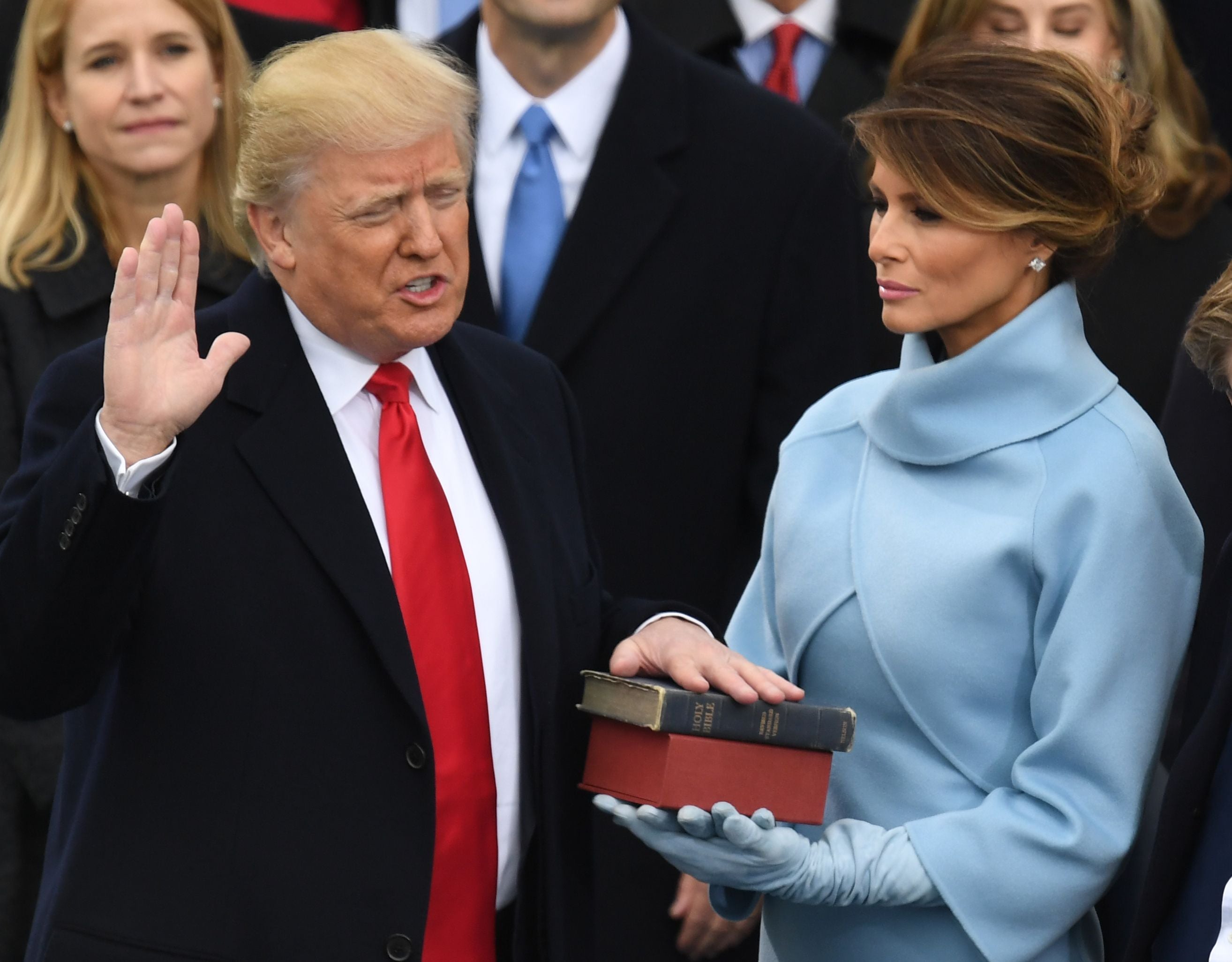 Melania Trump holds the Bible as her husband Donald Trump is sworn in as president on 20 January 2017