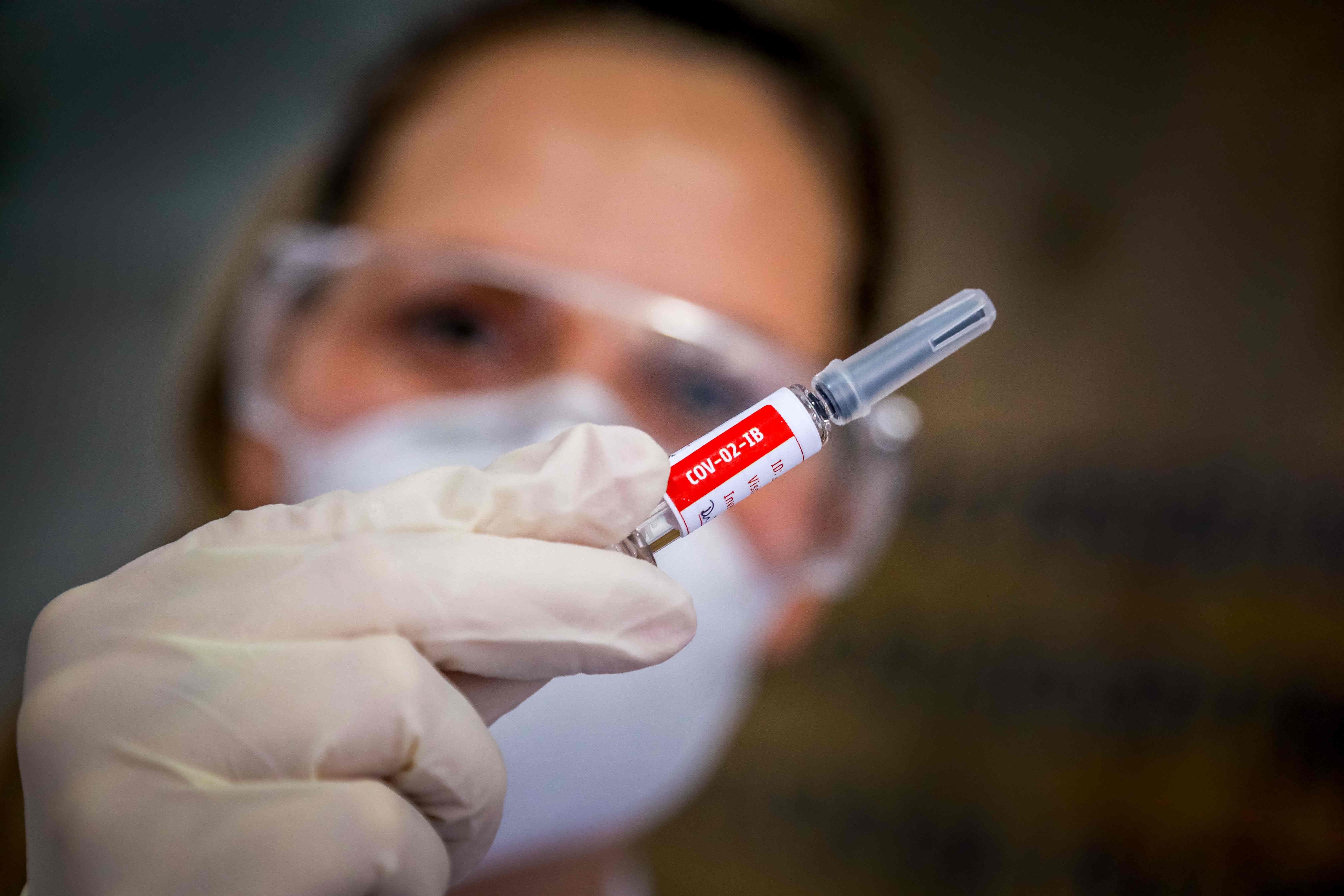 A nurse shows a COVID-19 coronavirus vaccine produced by Chinese company Sinovac Biotech at Sao Lucas Hospital in Porto Alegre, southern Brazil. (Photo by SILVIO AVILA/AFP via Getty Images)