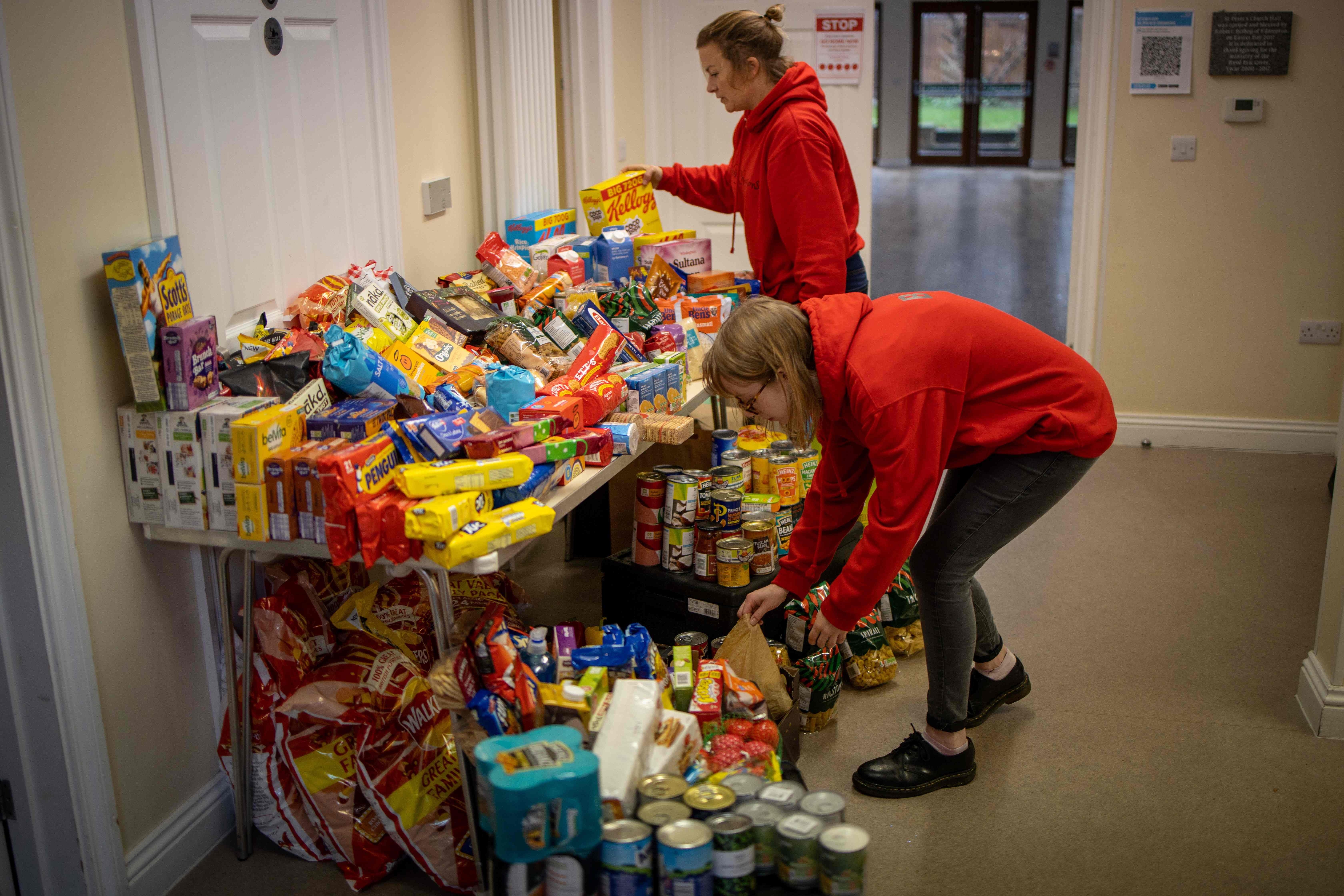 Staff organise food donations for families at the Cooking Champions food bank in Grange Park, London