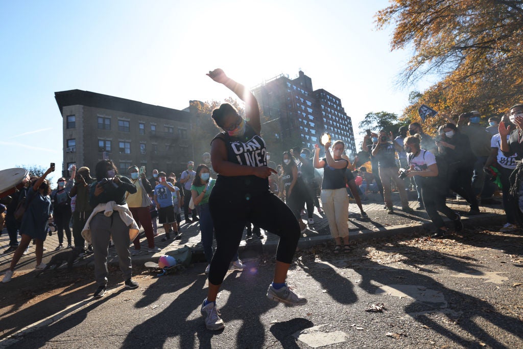 People celebrate at the entrance to Prospect Park after Joe Biden was declared winner of the 2020 presidential election