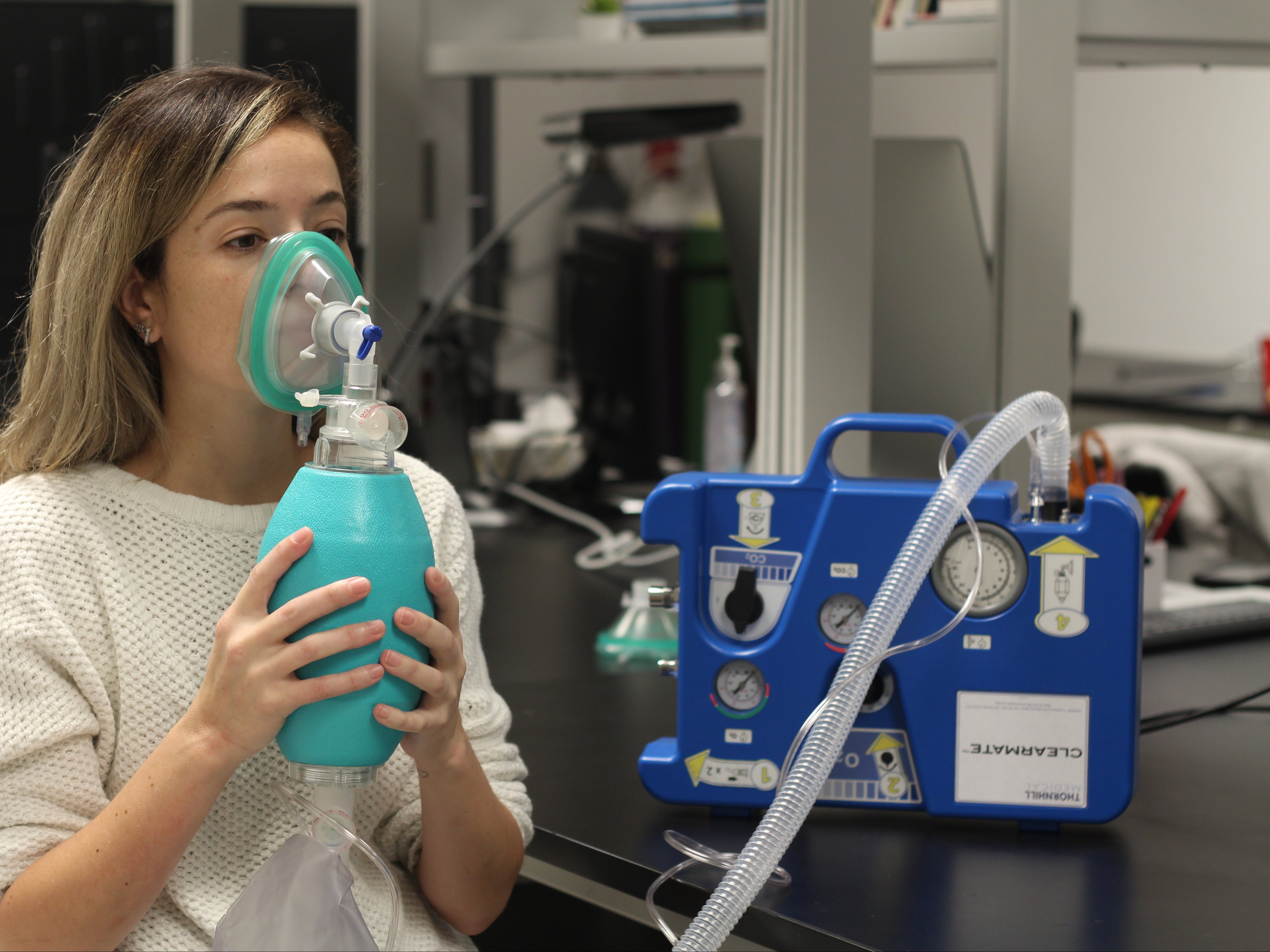 A volunteer demonstrates how the Clearmate device works to help patients hyperventilate to reduce alcohol or carbon monoxide poisoning