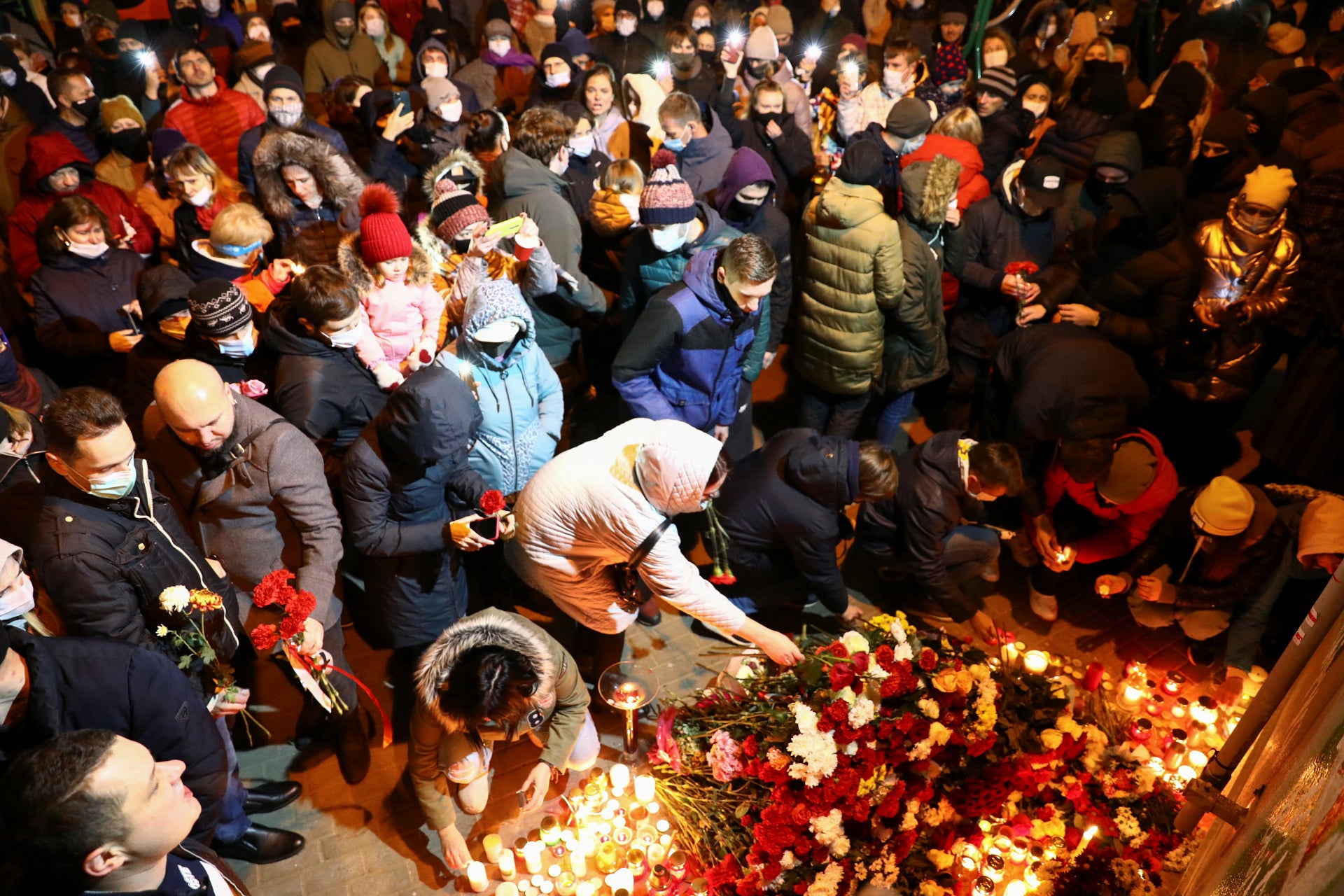 People gather to mourn the death of anti-government protester Raman Bandarenka who they say was beaten by Belarusian security forces in Minsk, Belarus