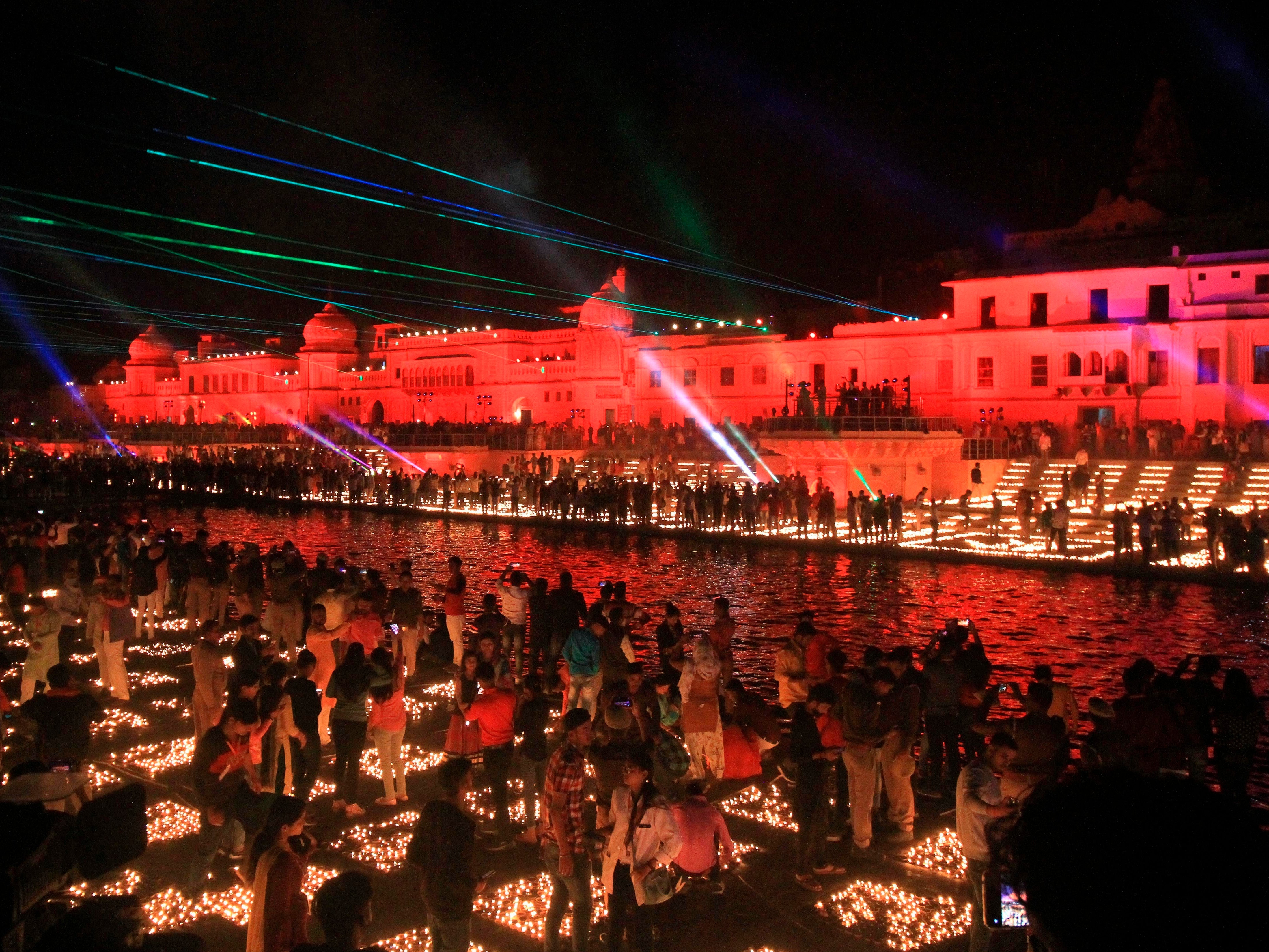 People light lamps on the banks of river Saryu in Ayodhya, India