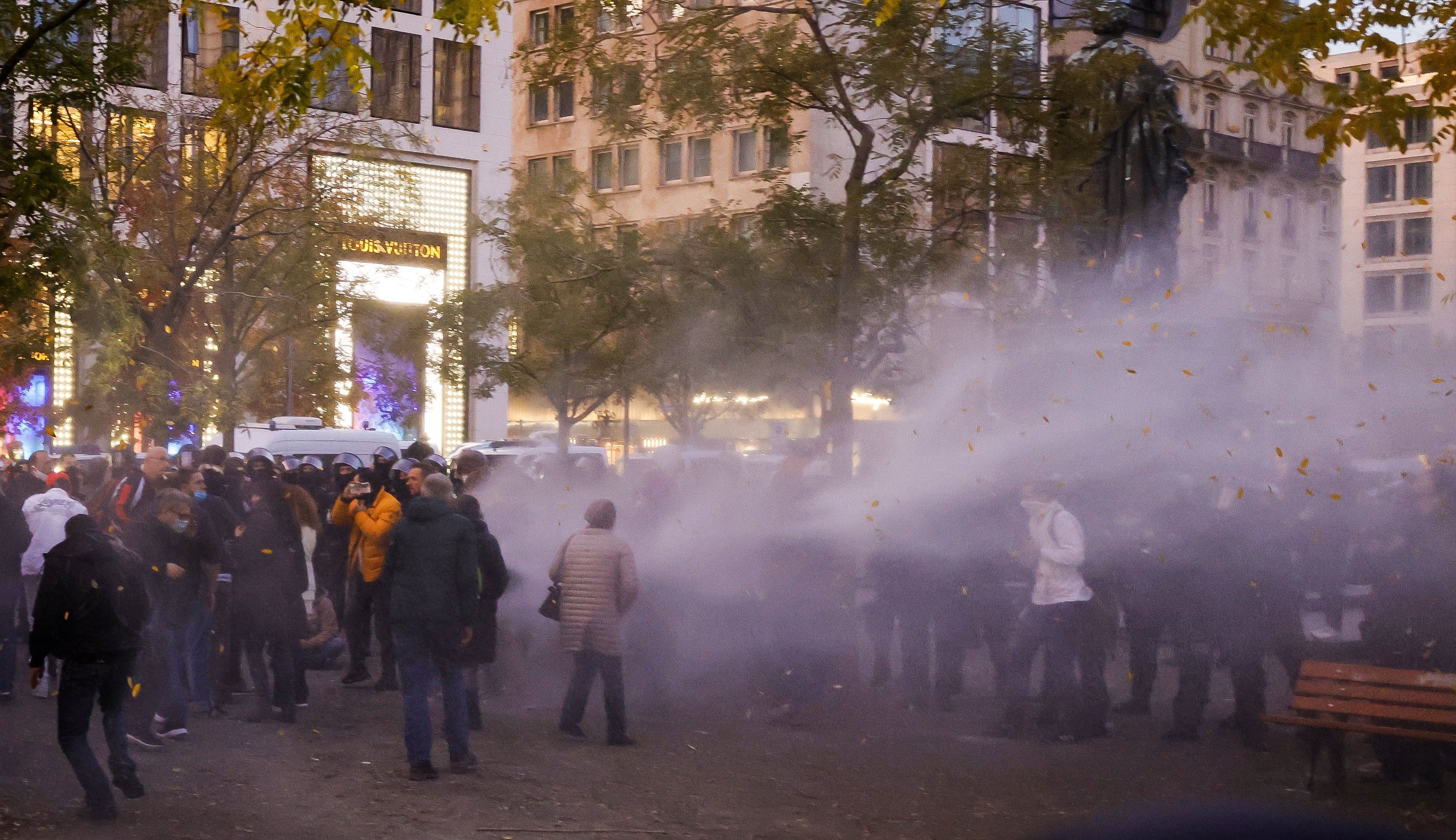 A water cannon fires against protesters who refuse to leave a demonstration against the coronavirus restrictions which was ended by the police due to violations of hygiene measures, in Frankfurt