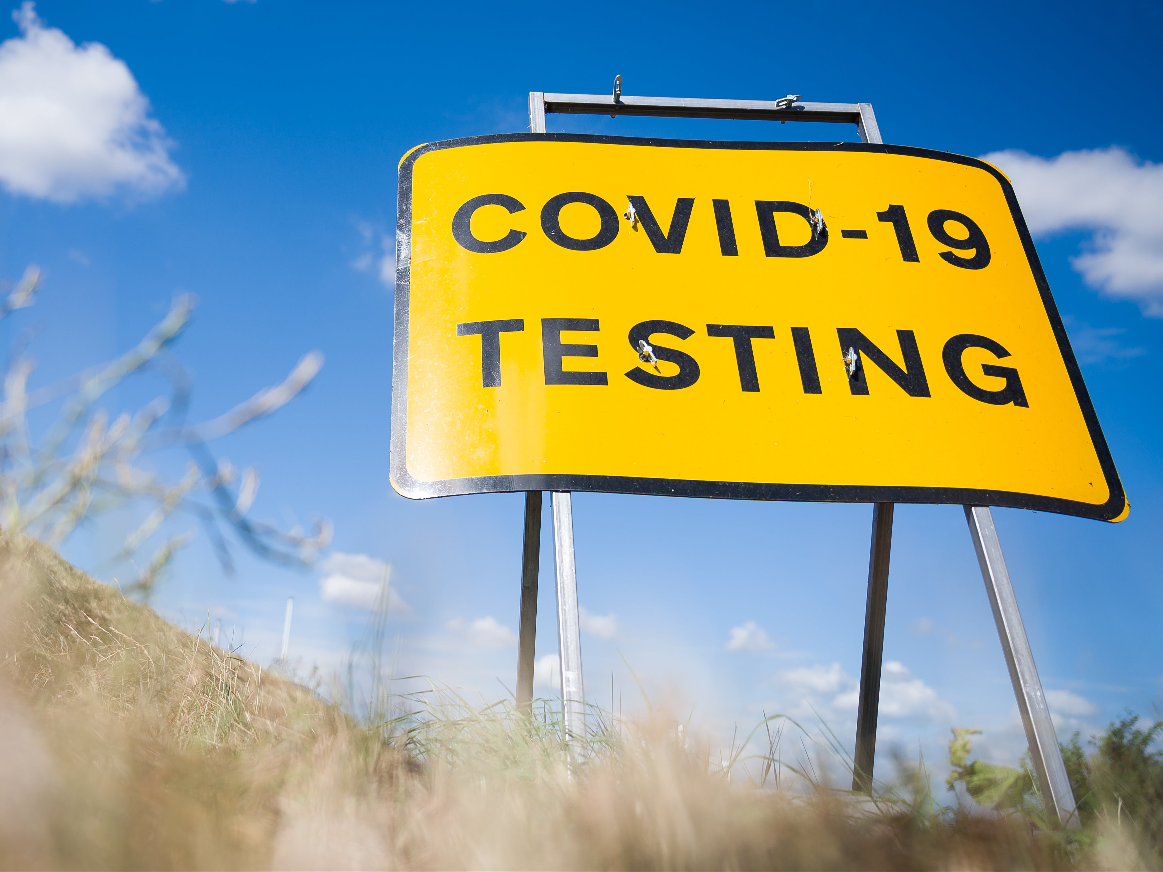 A traffic sign directs people towards the temporary testing centre