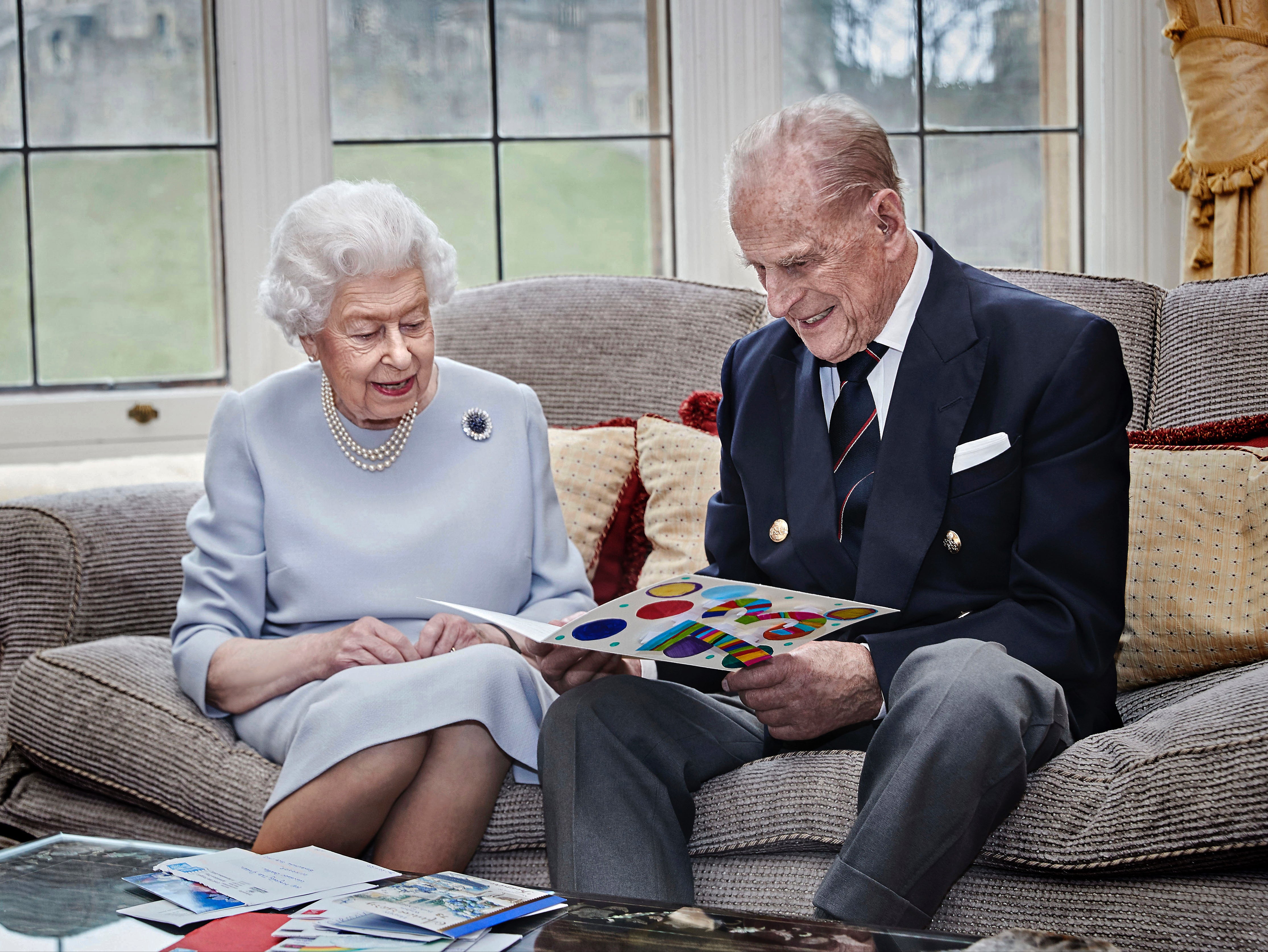 Queen and Prince Philip mark 73rd wedding anniversary with photo of them admiring handmade card from great grandchildren