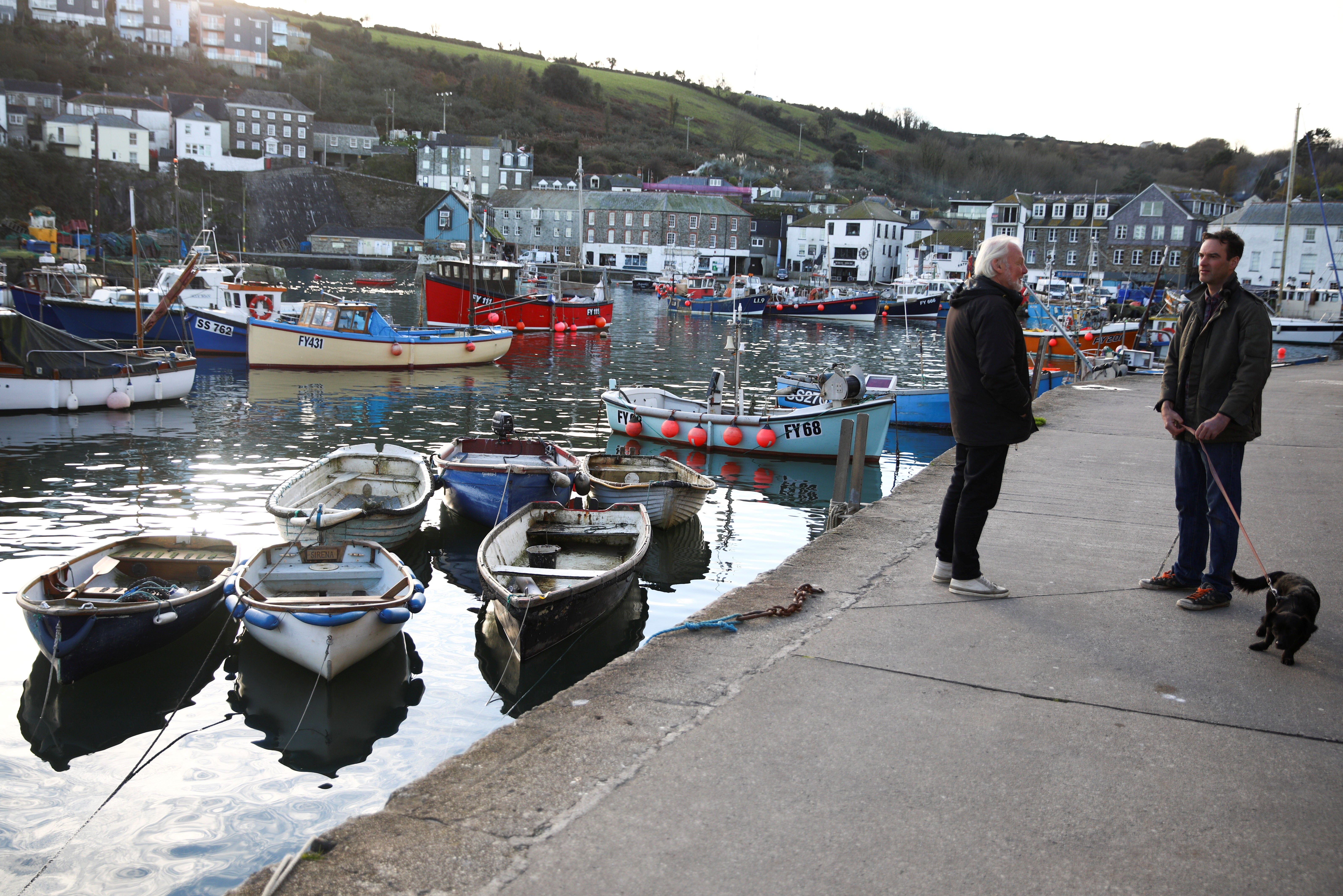 People talk in Mevagissey, amid the outbreak of coronavirus (ovid-19) in Cornwall, Britain on 26 November 2020.