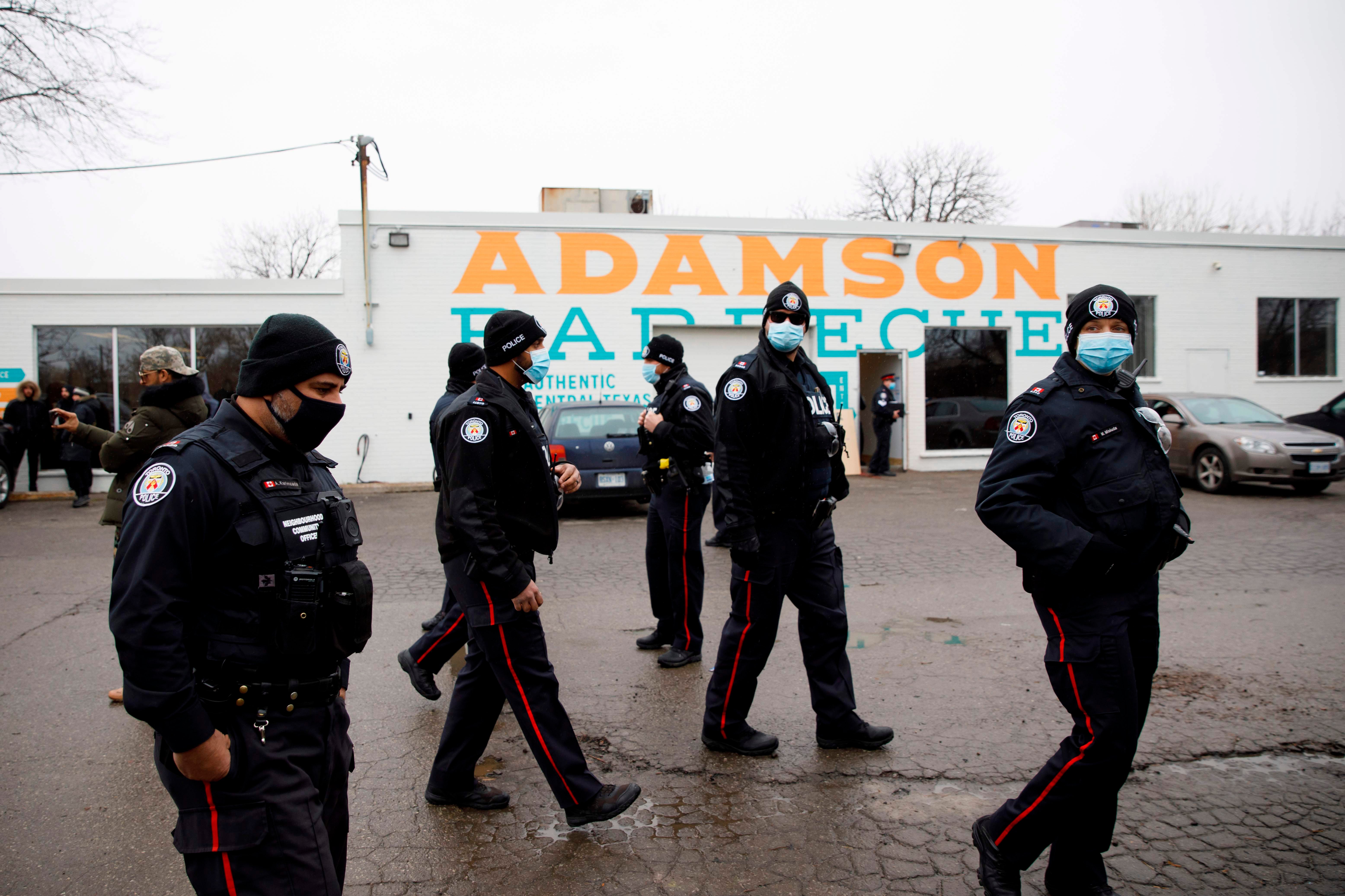 Police gather in the car park of Adamson Barbecue