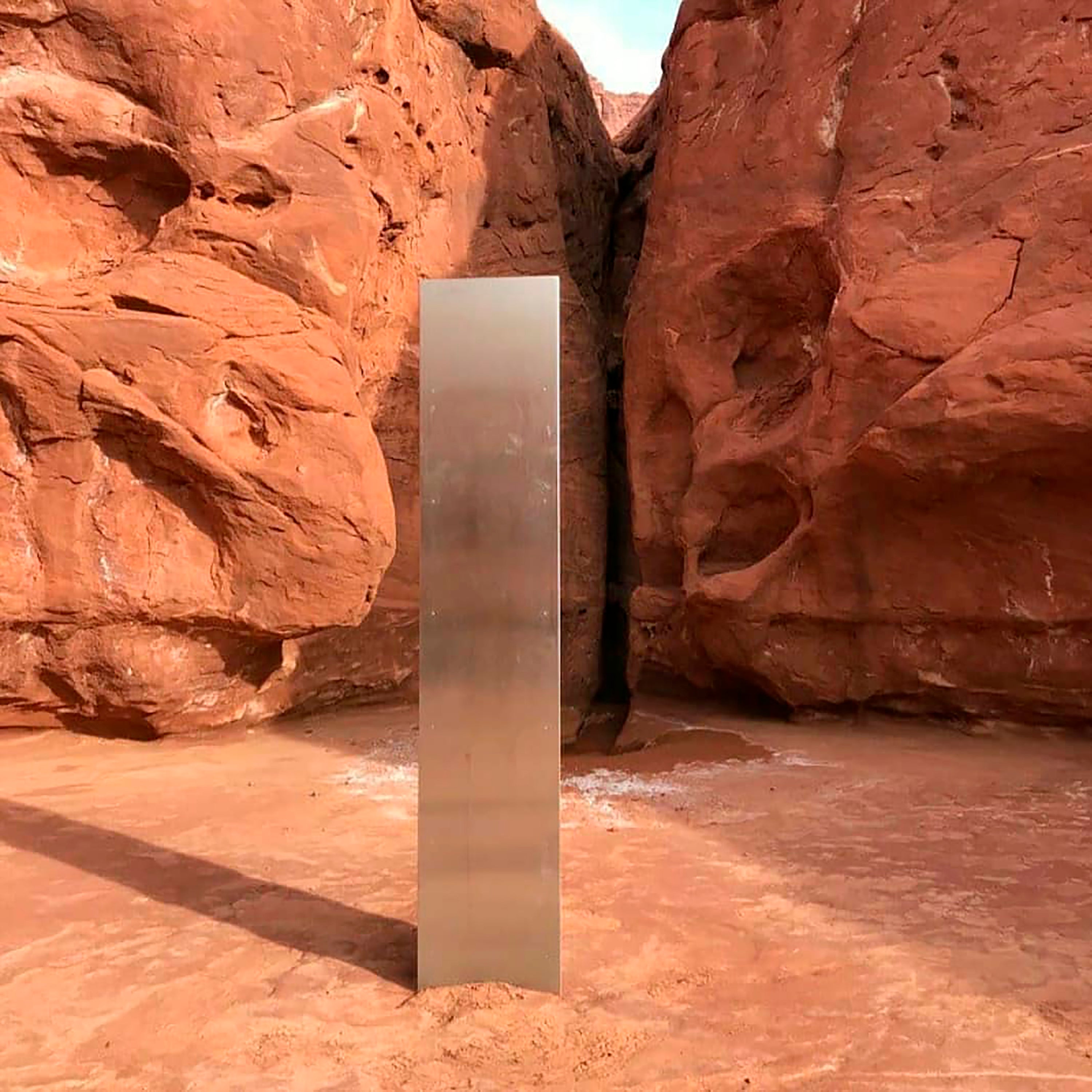 A metal monolith in the ground in a remote area of red rock in Utah. The mysterious silver monolith that was placed in the Utah desert has disappeared less than 10 days after it was spotted by wildlife biologists performing a helicopter survey of bighorn sheep, federal officials and witnesses said