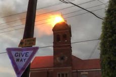 Lightning strike sets heritage bell tower ablaze in Sydney as storm cuts power for tens of thousands