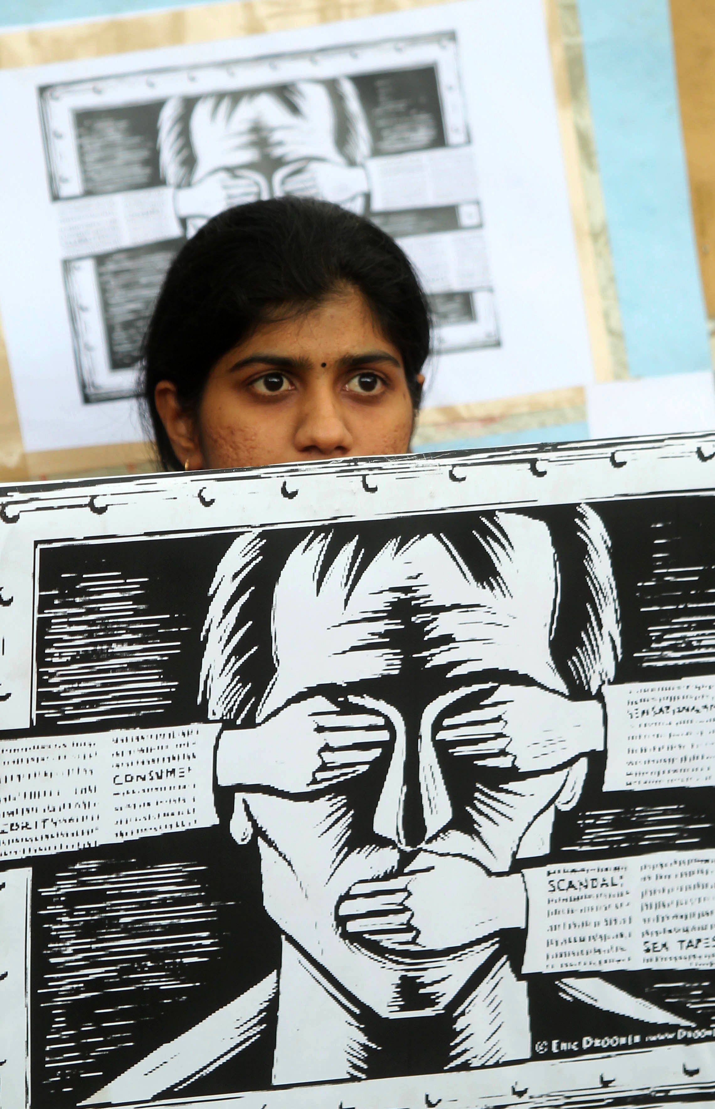 File image: An activist supporting the group Anonymous holds a poster as they protest against the Indian Government's increasingly restrictive regulation of the internet outside a shopping mall in Bangalore on June 9, 2012.