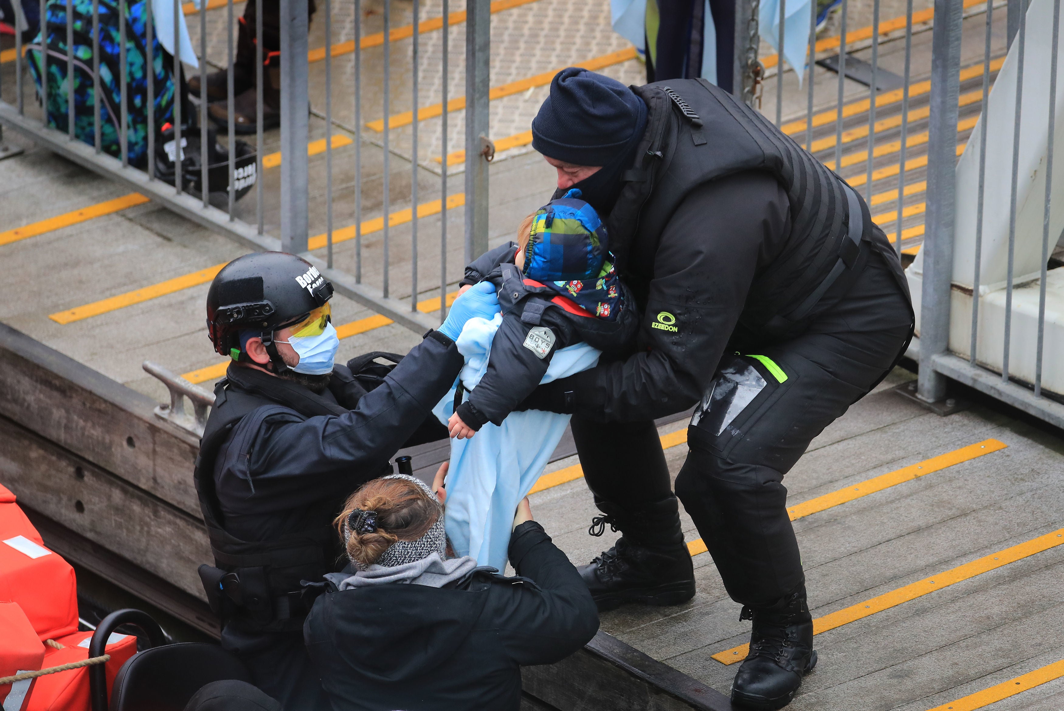 A group of people including young children are brought in to Dover