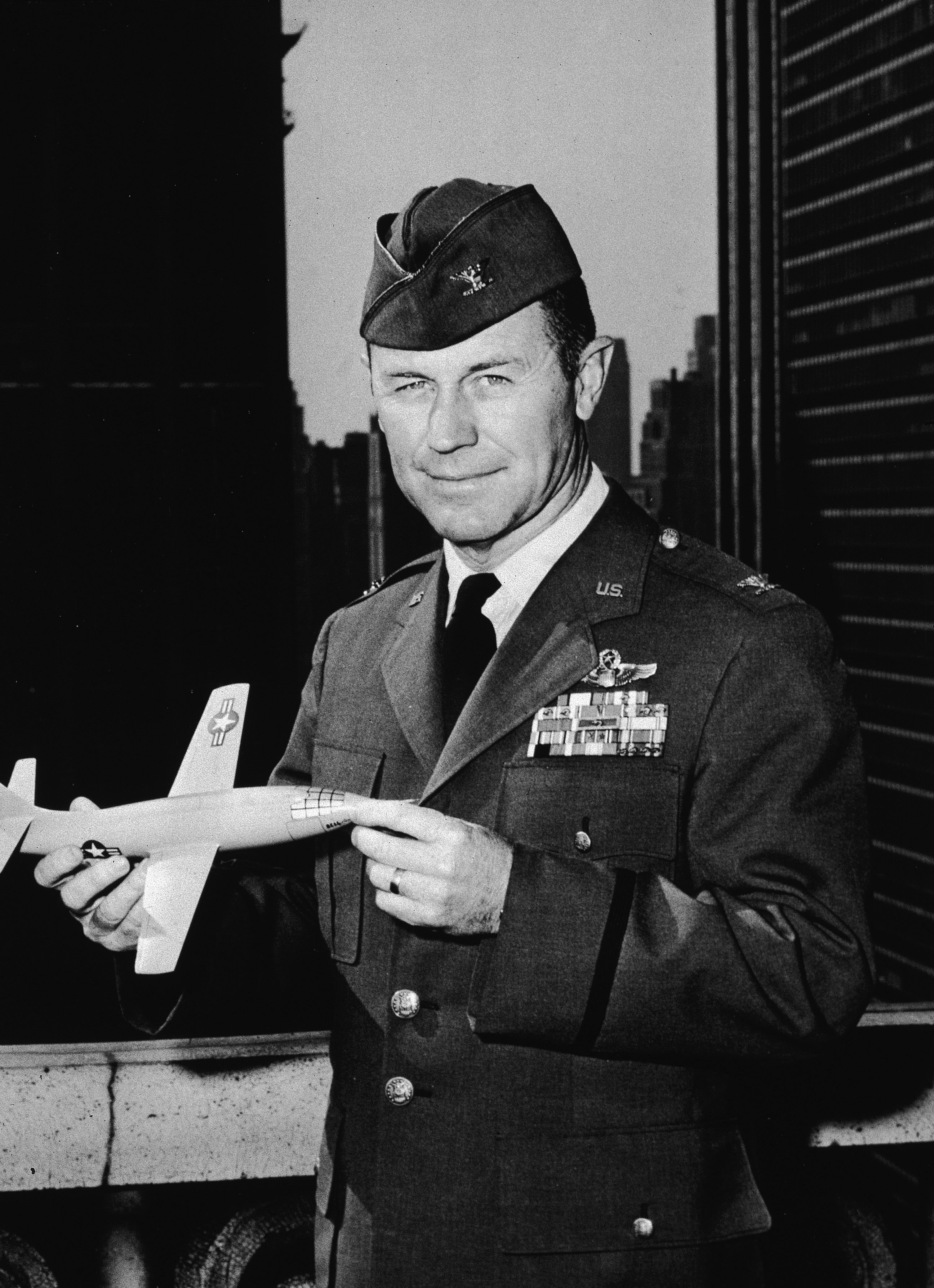 Holding a model of the plane he flew to break the sound barrier