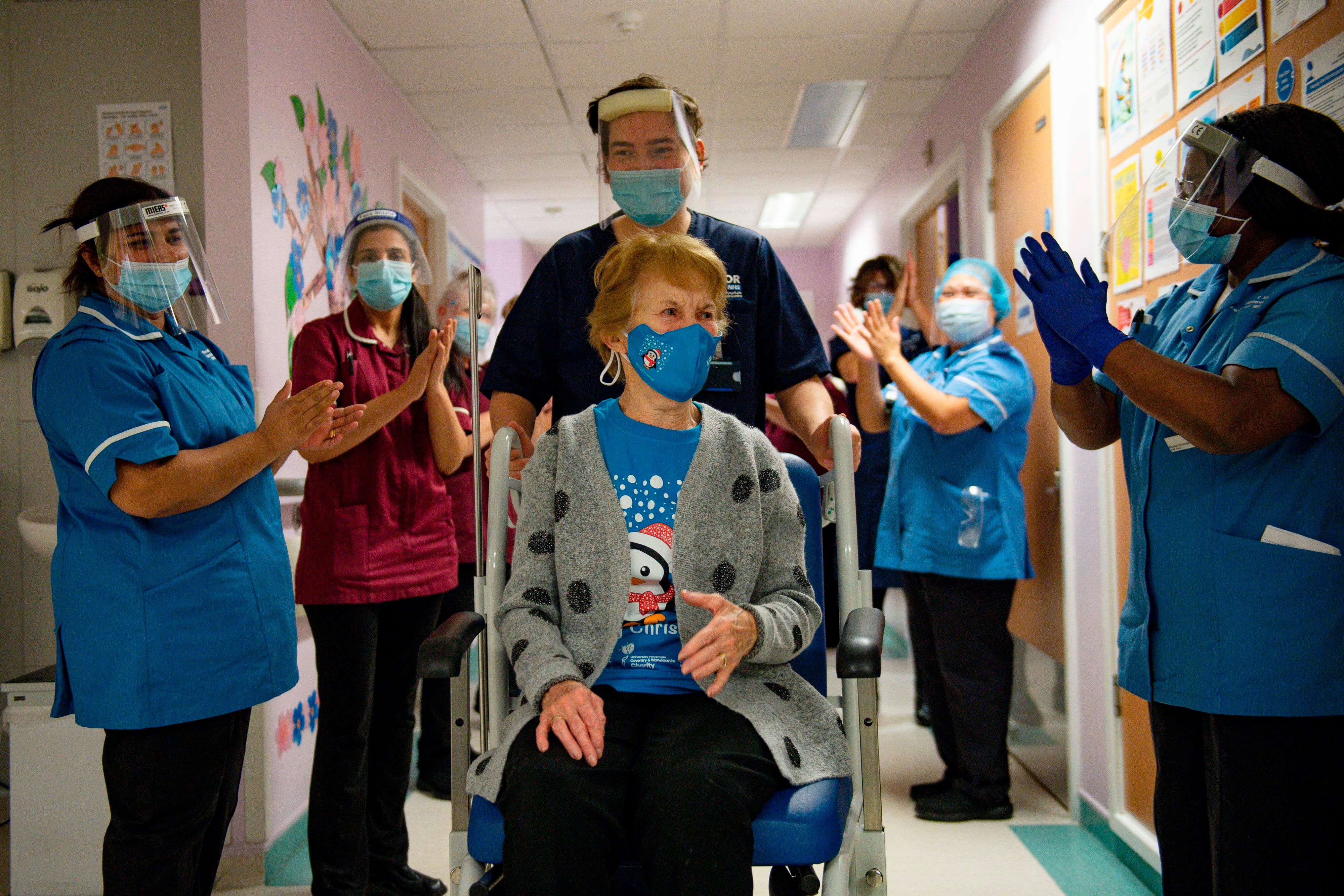 Margaret Keenan in Coventry is applauded by nurses as she becomes the first person in the world to get the Pfizer vaccine