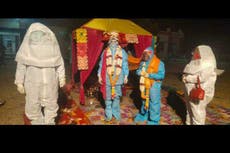 In sickness and in health: Indian couple get married in hazmat suits after bride test positive for Covid