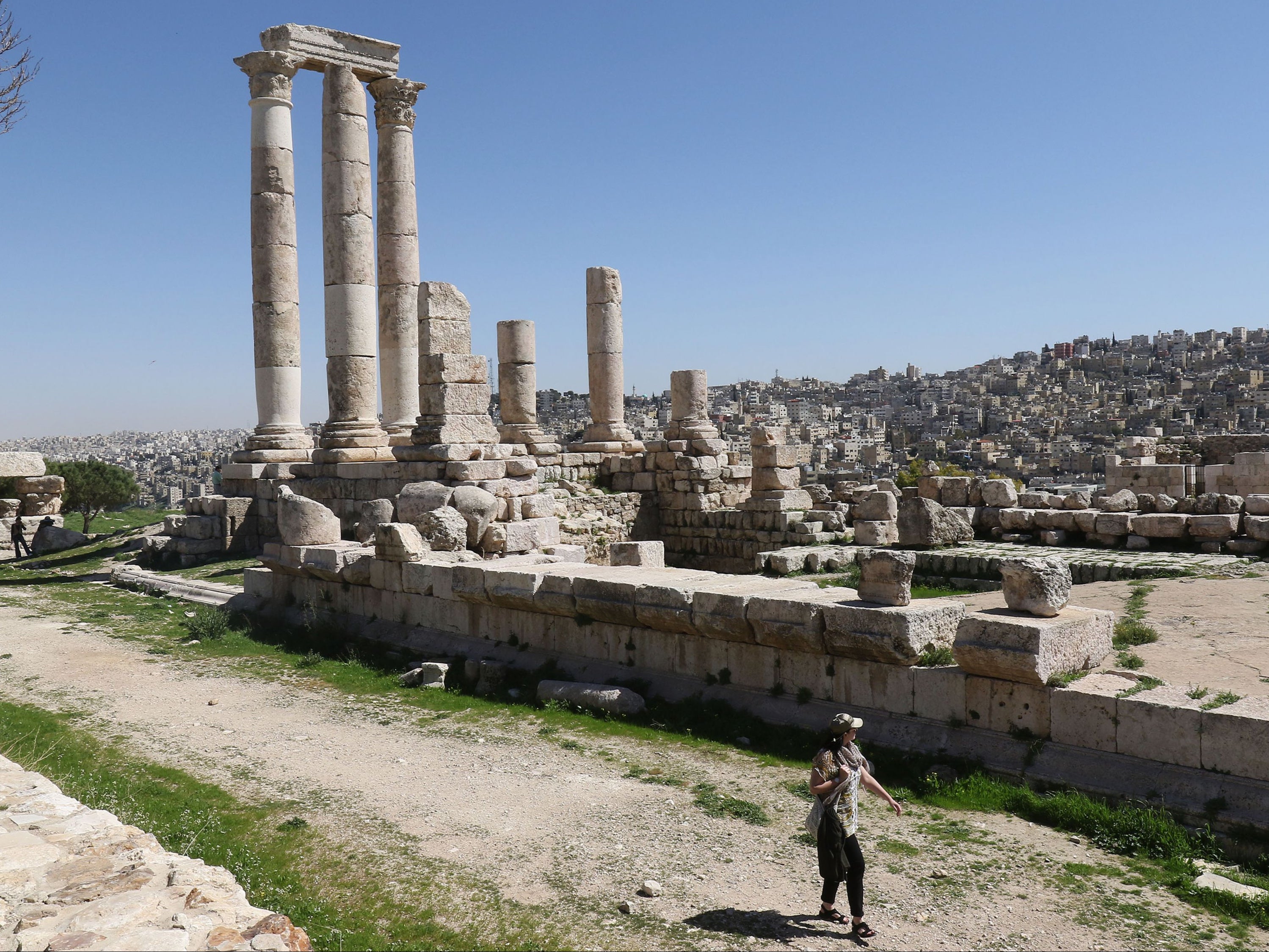 A tourist walks past the Temple of Hercules in Amman