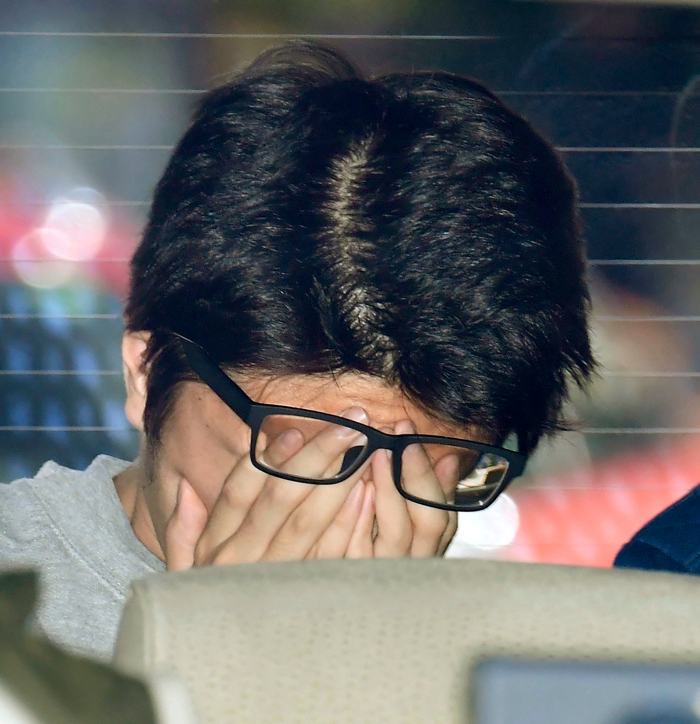 Takahiro Shiraishi covers his face after he was given the death sentence