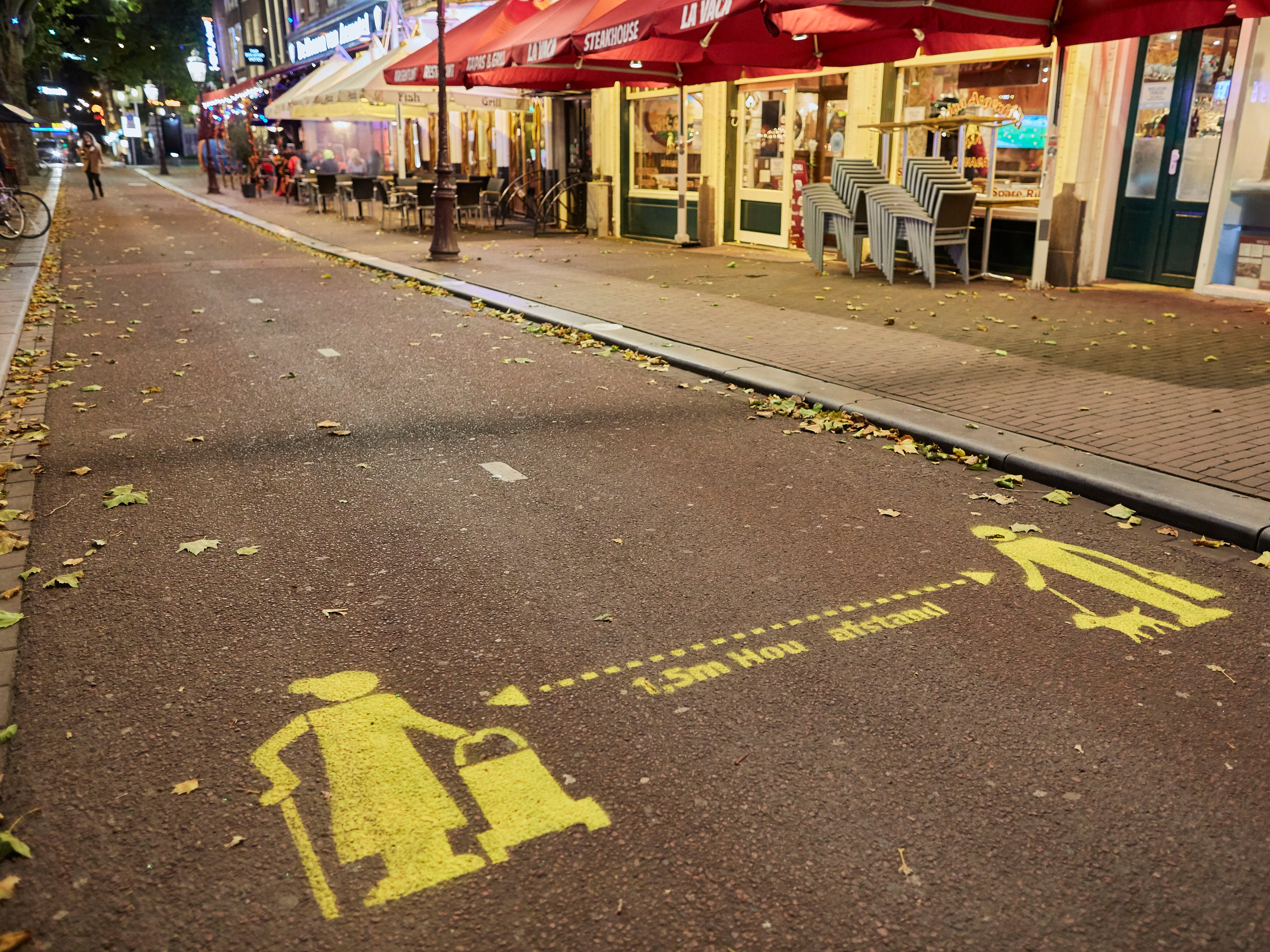 A sign warning for social distancing outside a terrace in Amsterdam