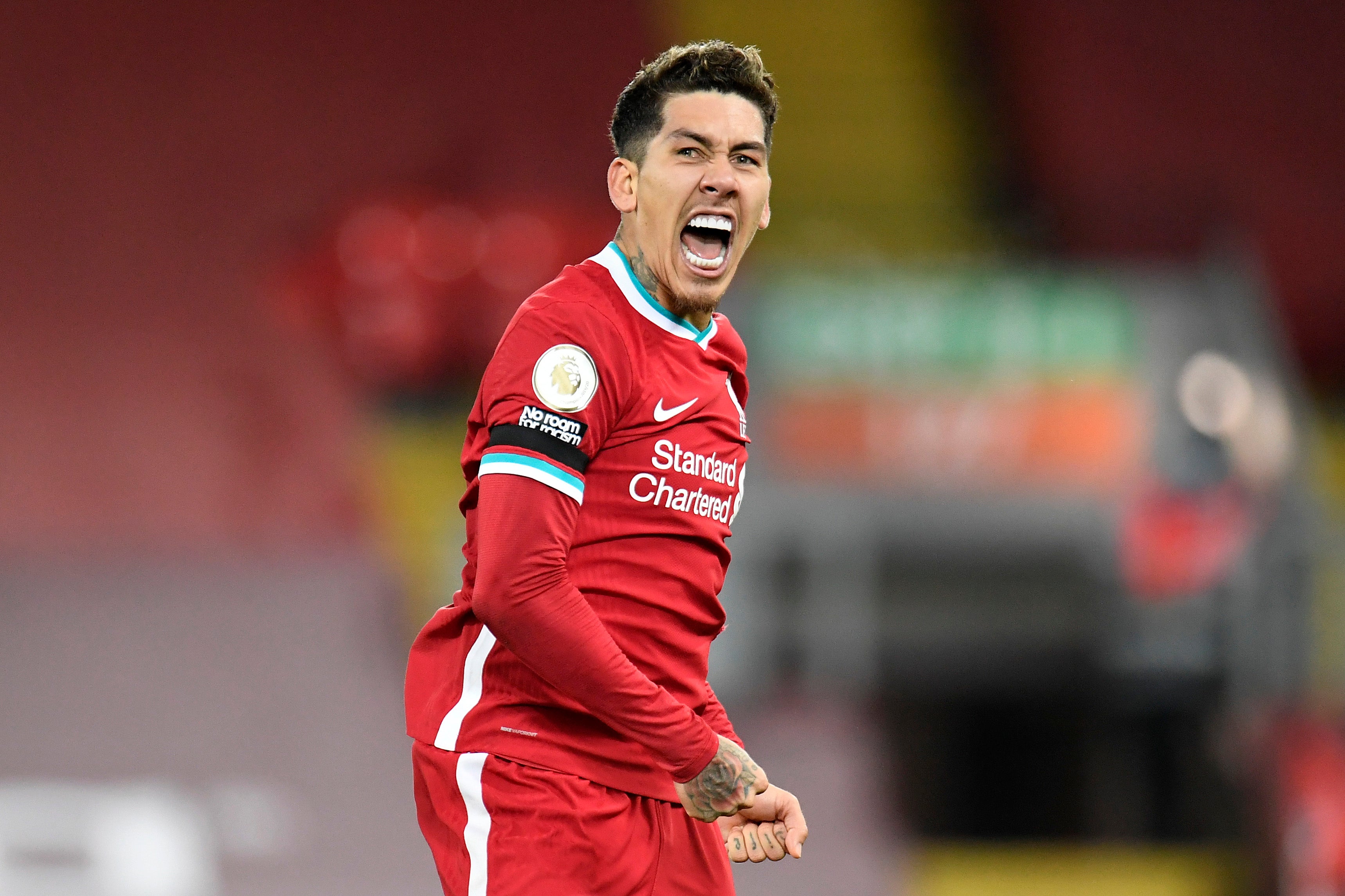 Roberto Firmino celebrates fiercely after scoring the winner