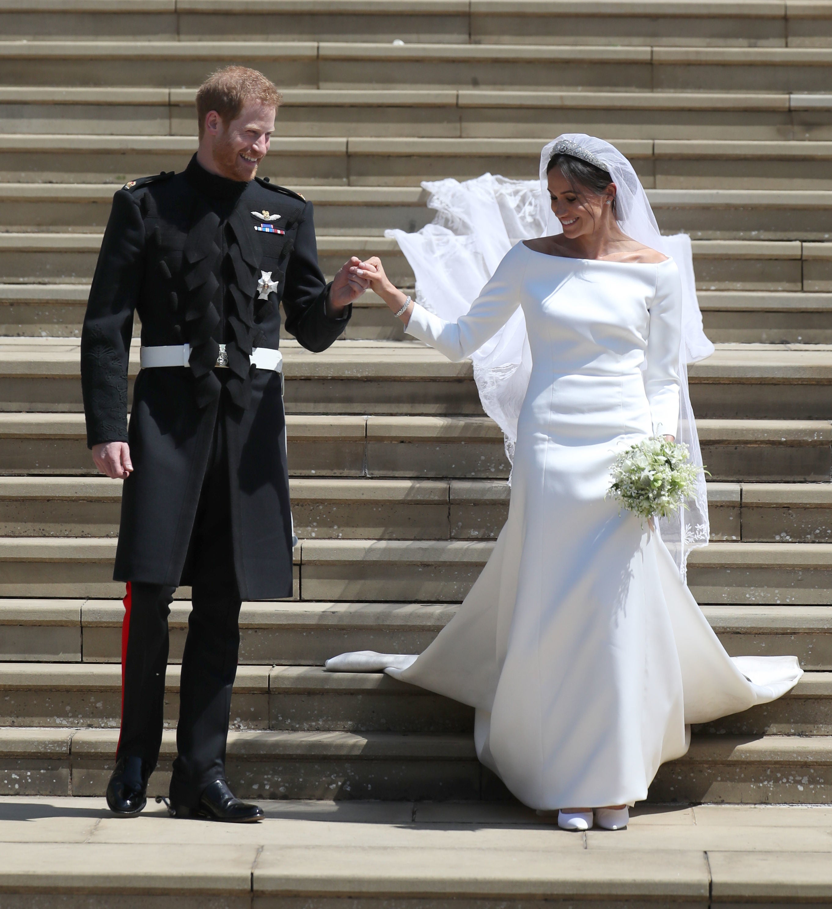Prince harry and Meghan, Duchess of Sussex, emerge from Windsor Castle on their wedding day in 2018