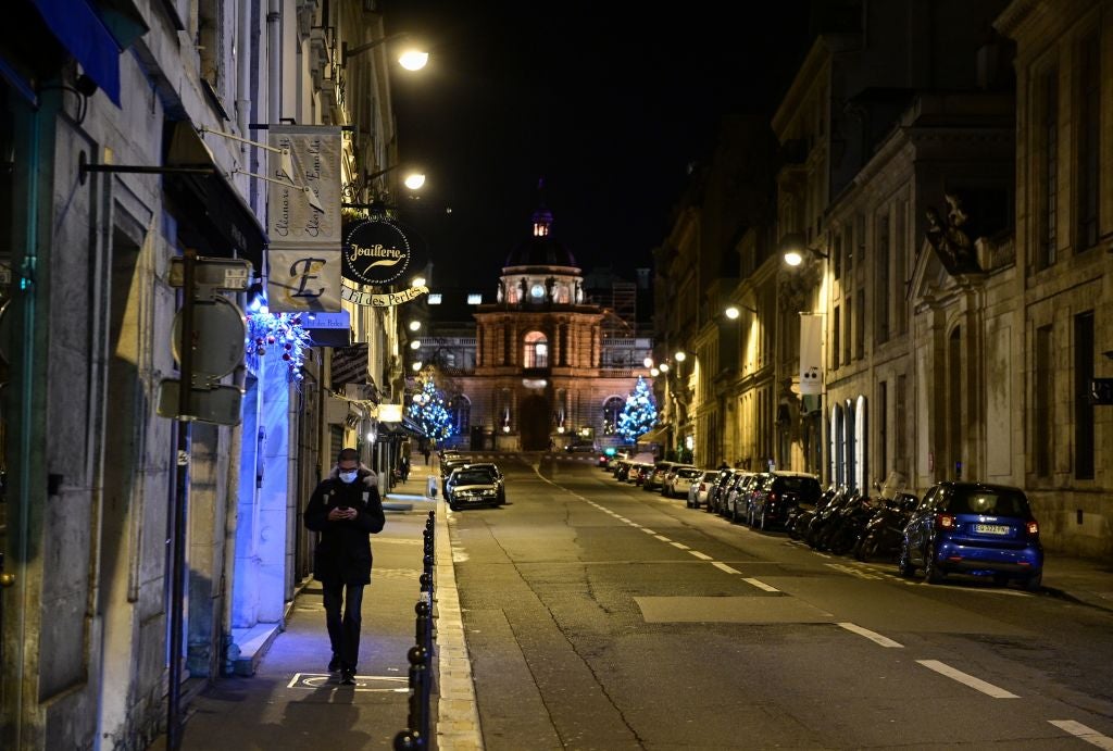 A man walks in a deserted street near the French senate in Paris on December 15