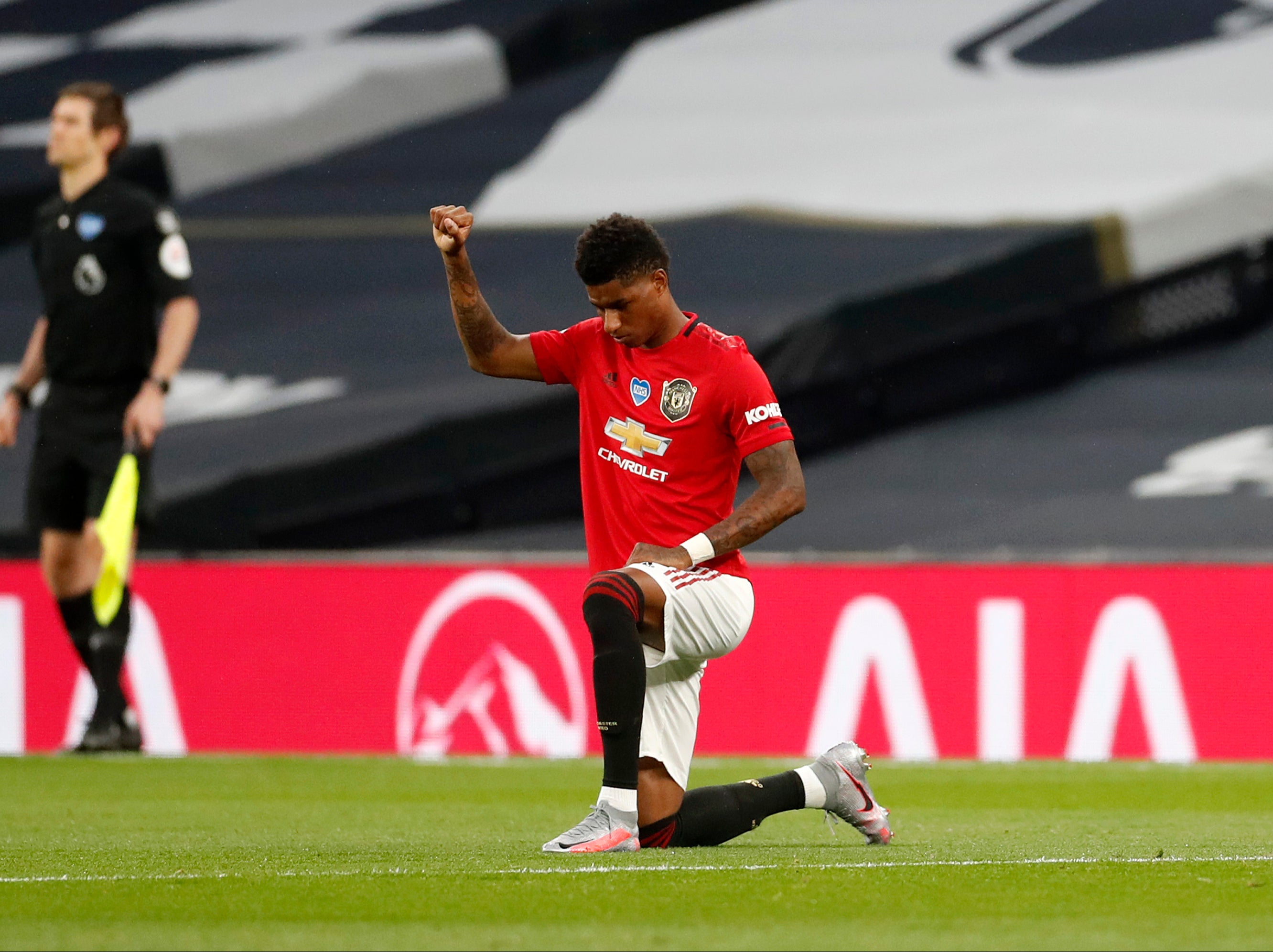 Marcus Rashford takes a knee as the Premier League returns in June