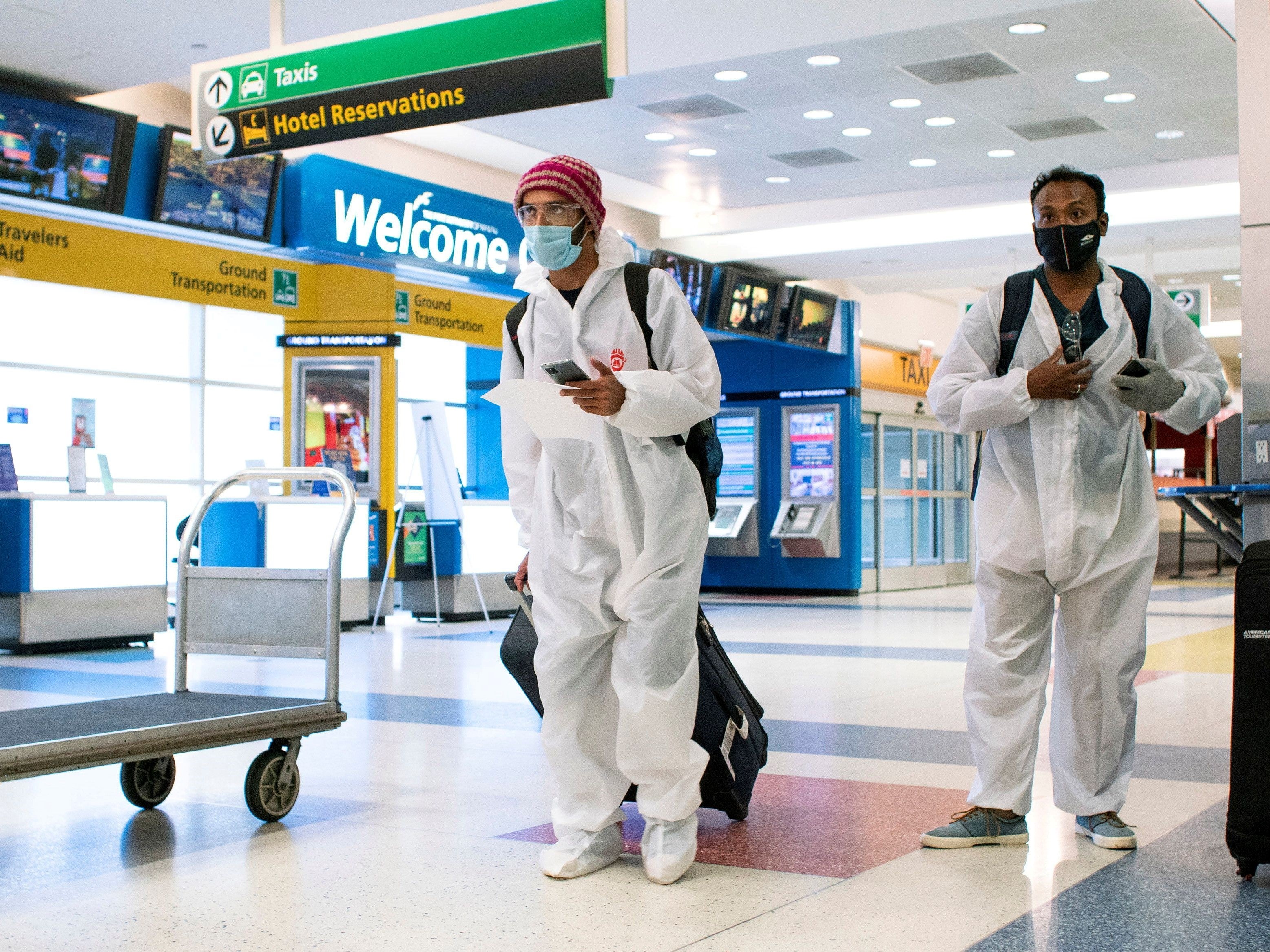 Passengers arrive on a flight from London to JFK International Airport in New York City ahead of new coronavirus restrictions