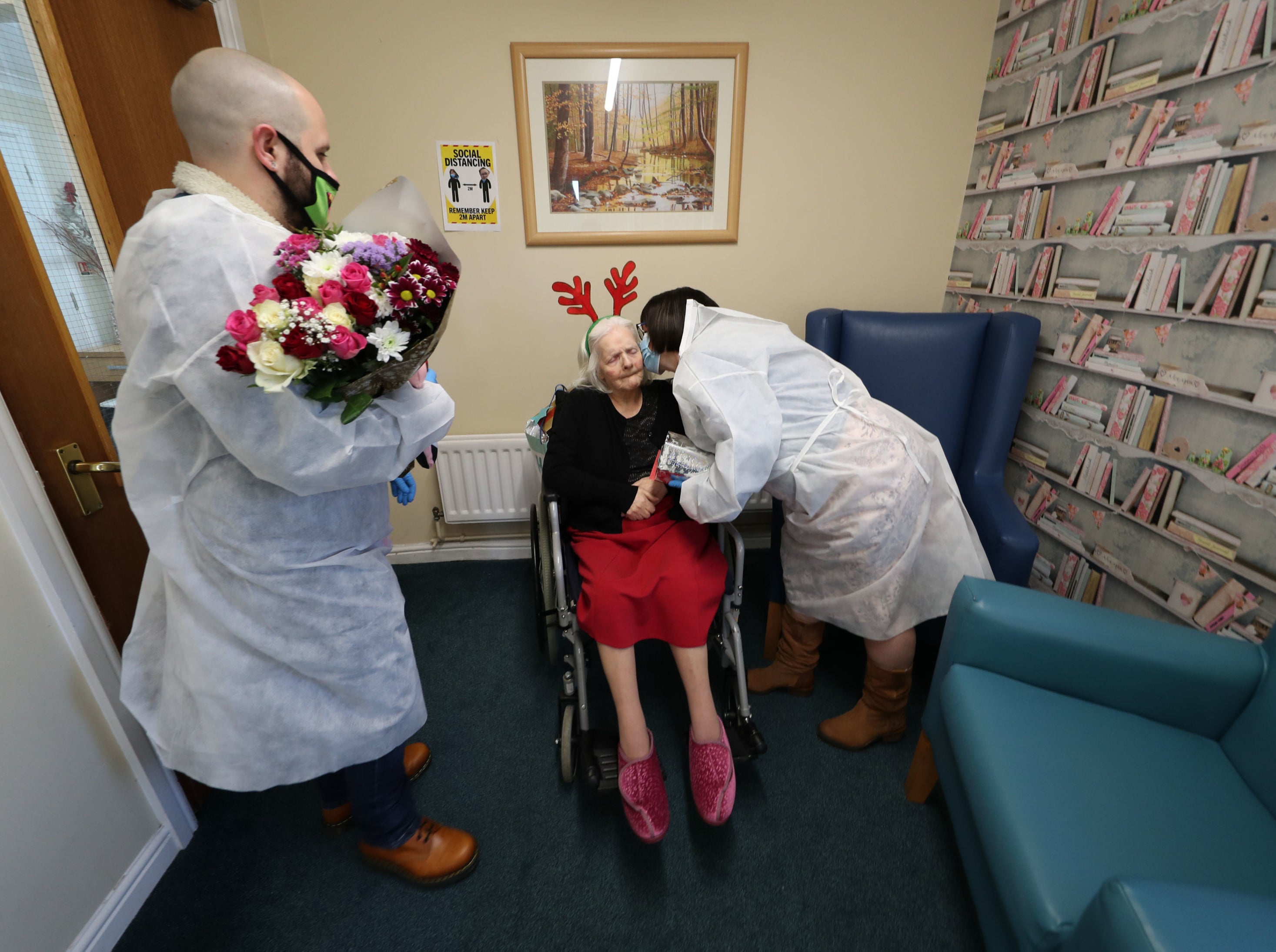 Mary Orme and her son Michael McKimm embrace their mother and grandmother, Rose McKimm, during a Christmas Day visit at Aspen Hill Village care home